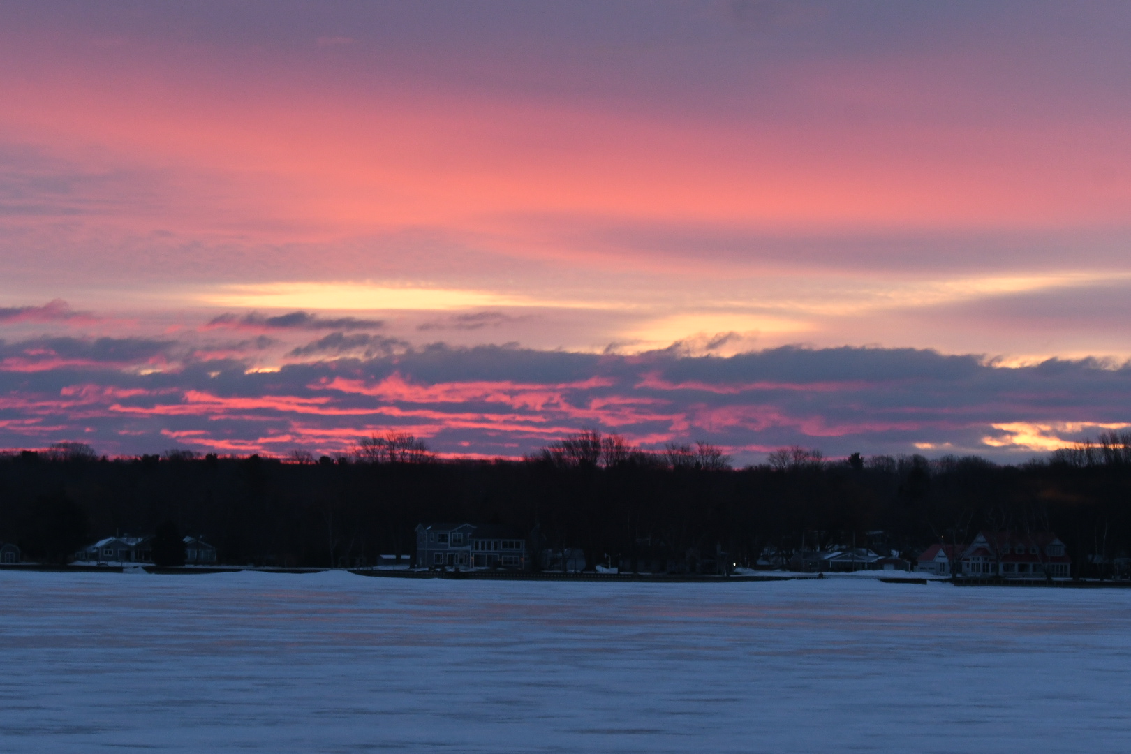 Sunrise over frozen Hamlin Lake in Mason County, Michigan.