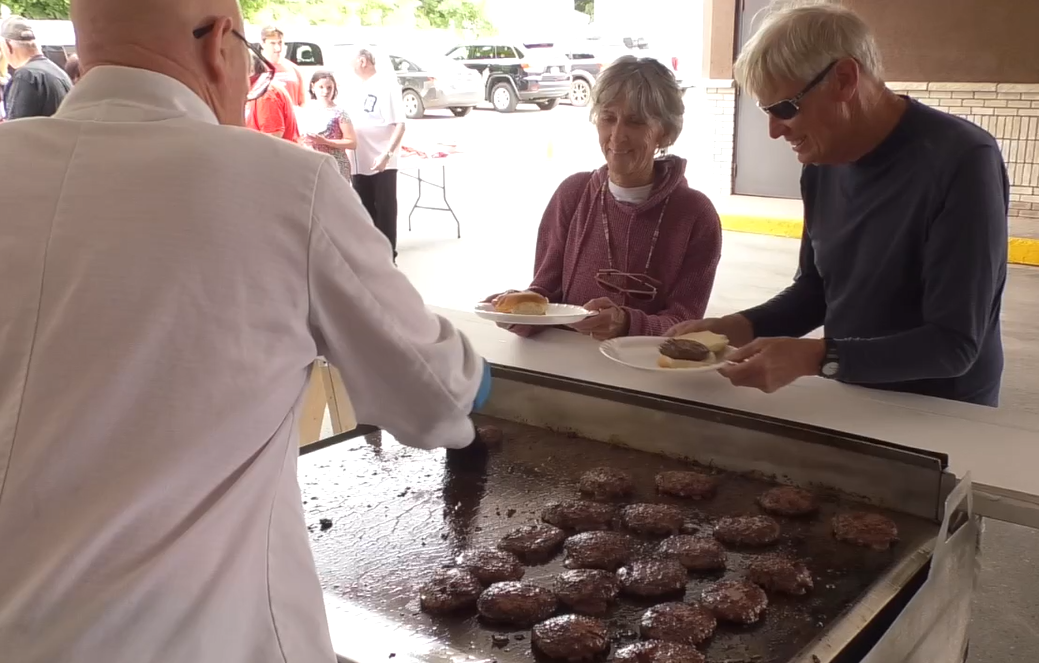 Volunteers served over 300 hamburgers at fundraising event.