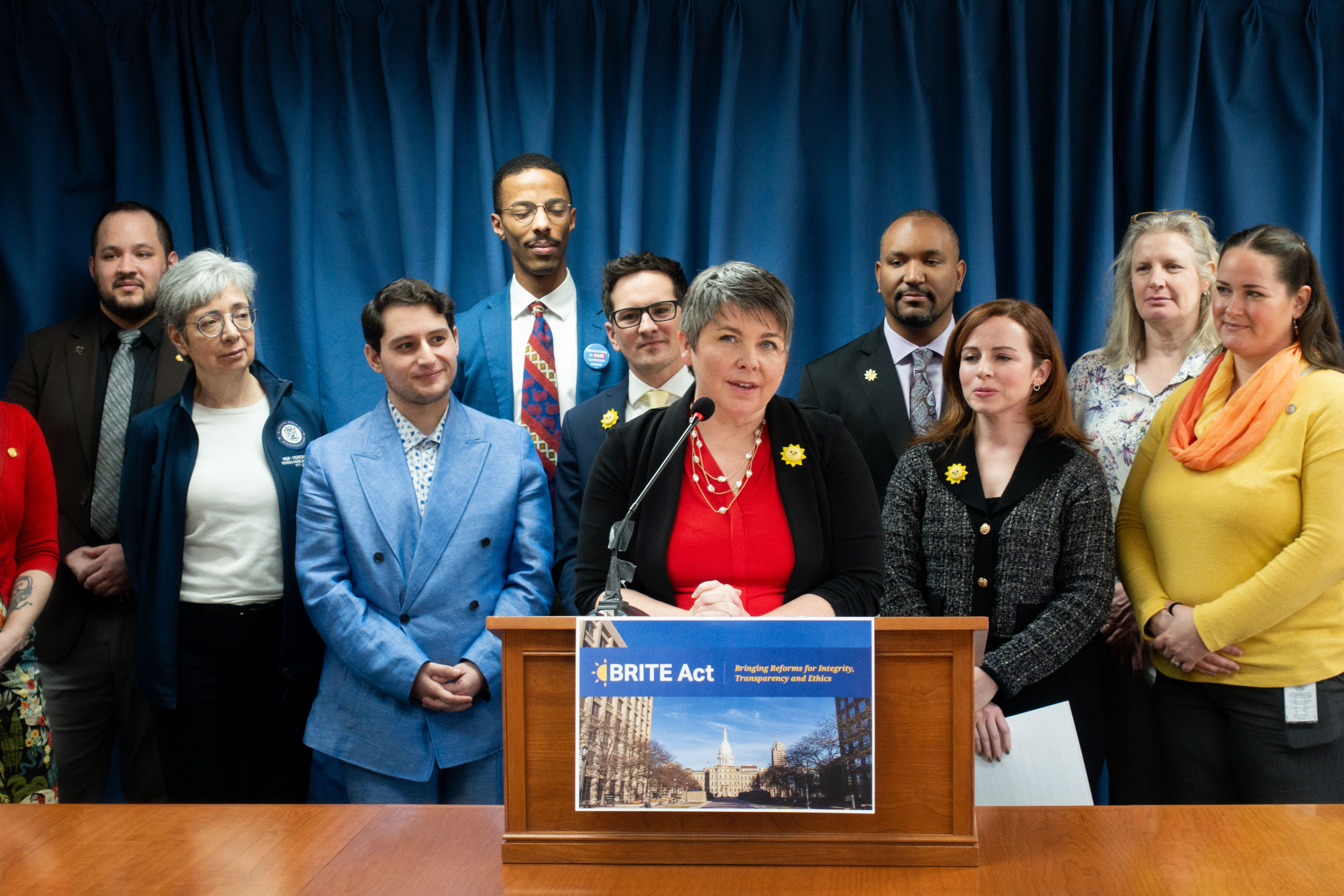 Rep. Betsy Coffia (center) of Traverse City speaks about the BRITE Act, a package of transparency bills.