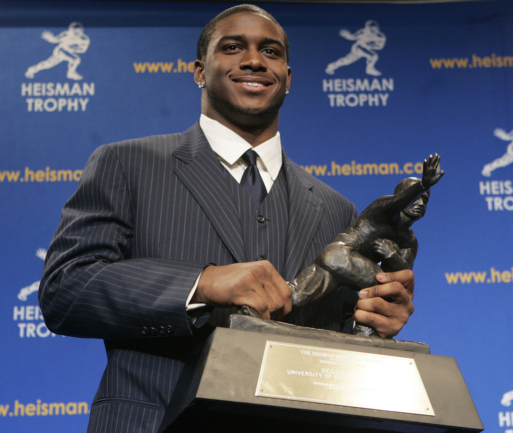 Heisman Trophy winner Reggie Bush of the University of Southern California smiles while posing for photos after a news conference in New York, Dec. 10, 2005.