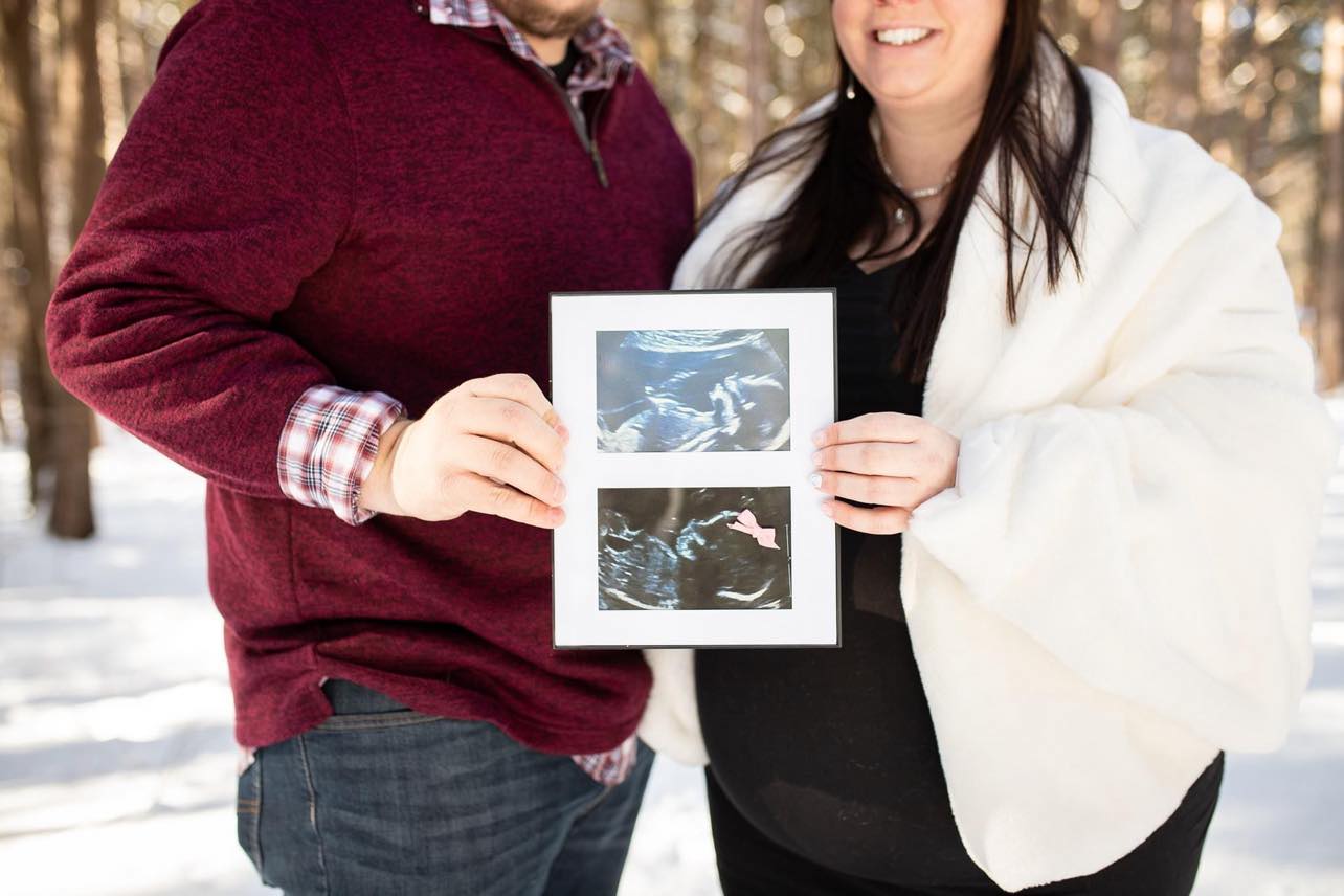 Ben and Katie Brooks holding their sonogram.