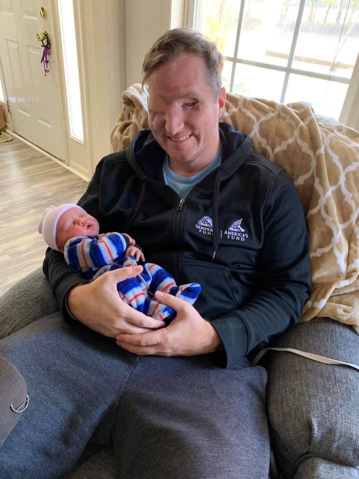 Jonathan Turnbull holds his newborn daughter Ellie.