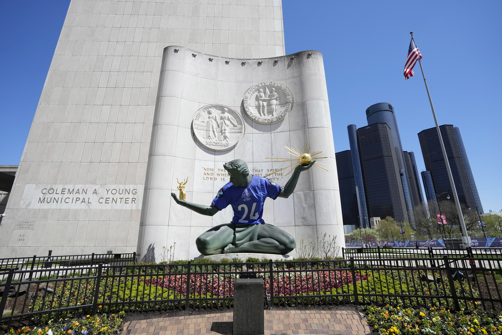 An NFL football draft jersey is displayed on the Spirit of Detroit statue Friday, April 19, 2024, in Detroit.