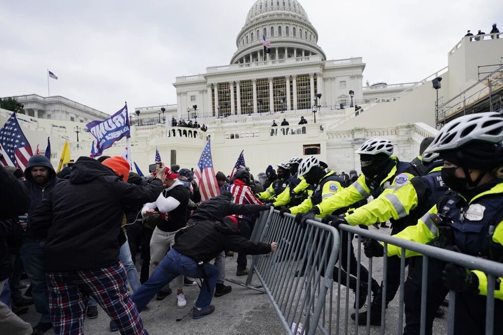 FILE - Rioters supporting President Donald Trump try to break through a police barrier at the Capitol in Washington, on Jan. 6, 2021