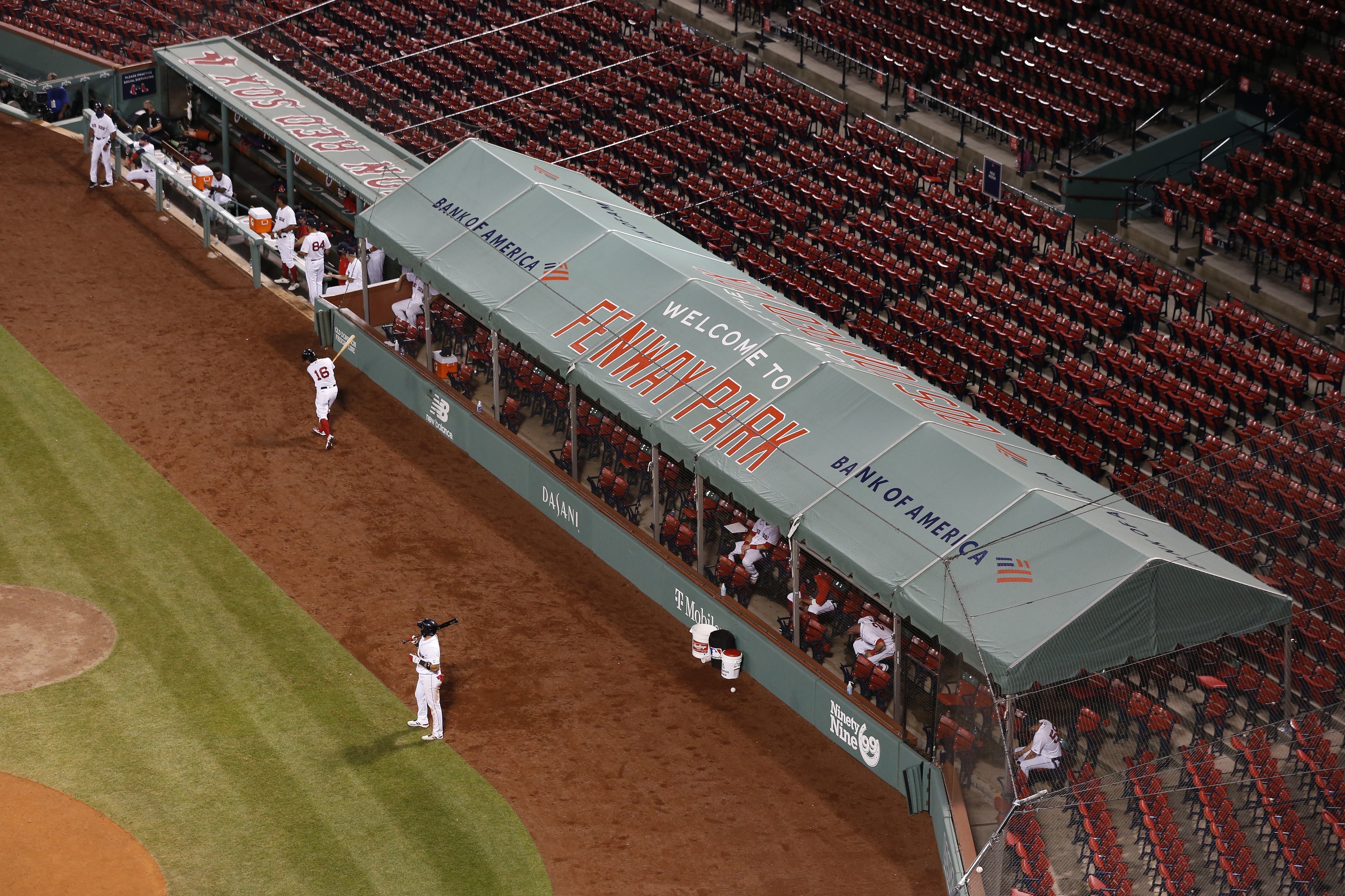 Empty stands, masked players as baseball returns