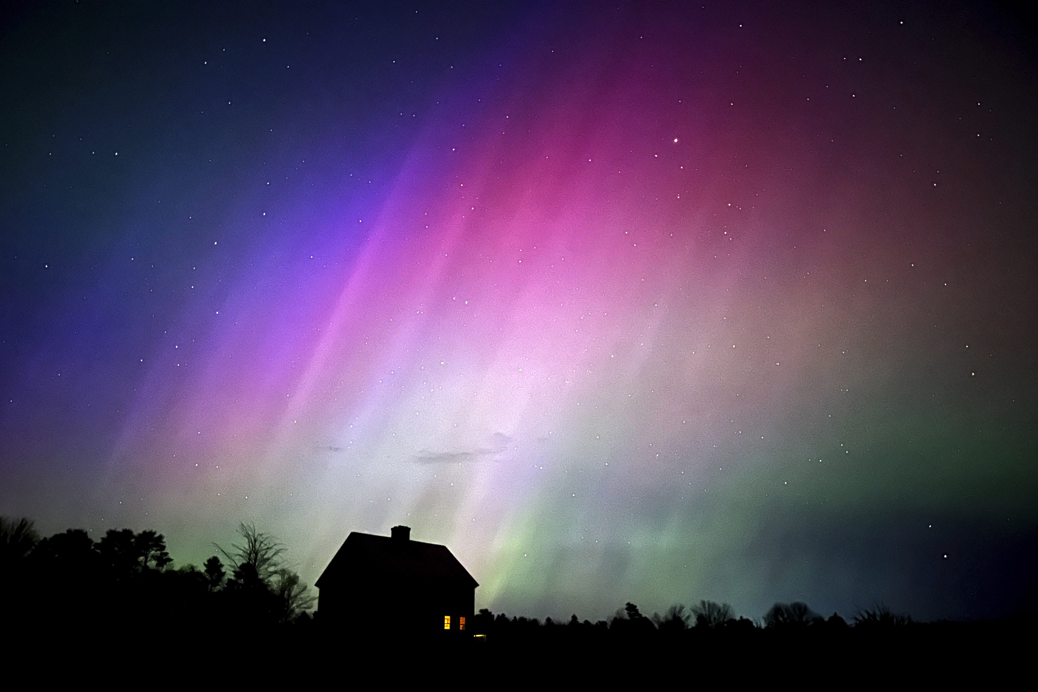 Solar storm hits Earth, producing colorful light shows across