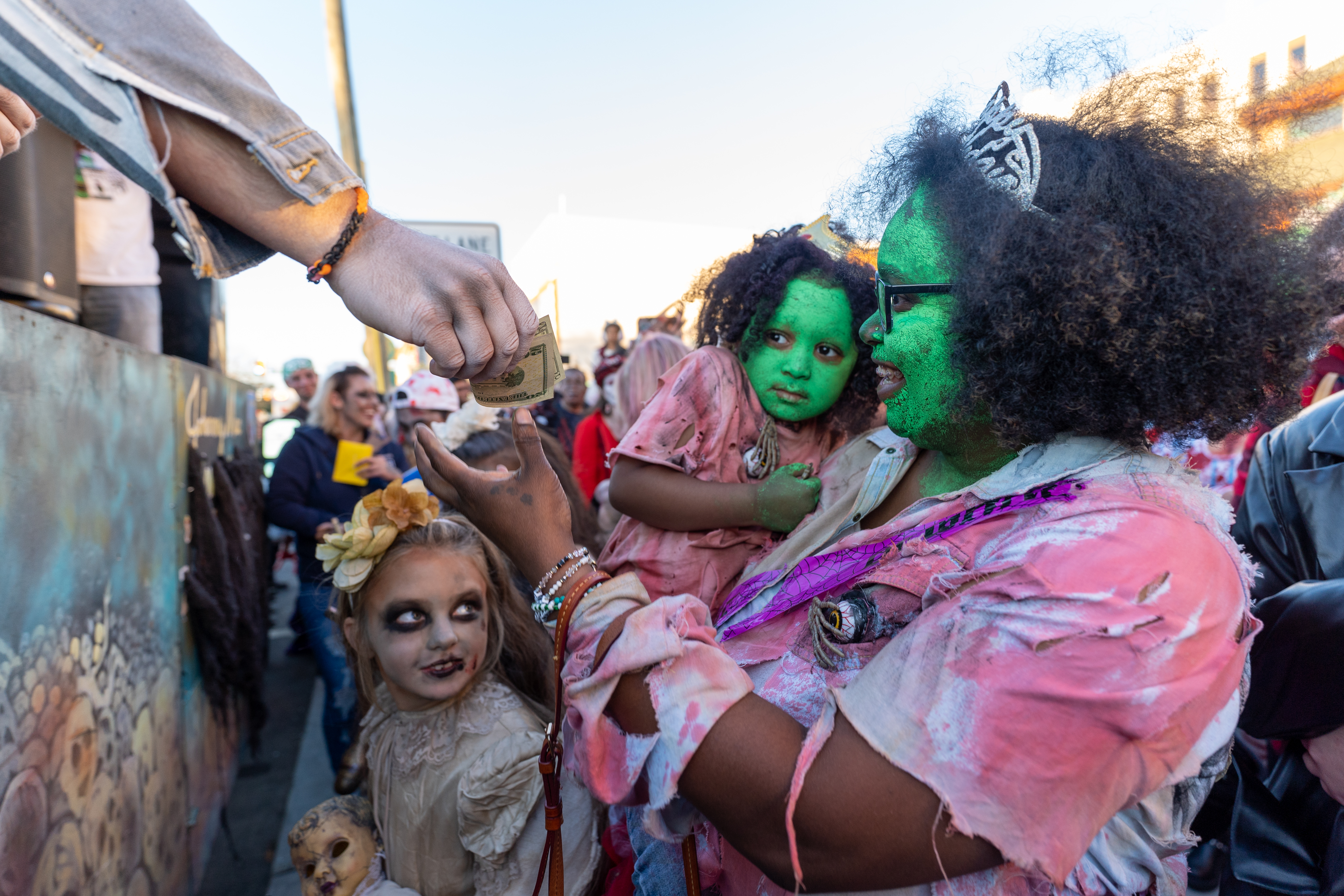 A zombie receives $20 as a runner-up prize in the zombie costume contest youth category during the 14th Asbury Park Zombie Walk in Asbury Park on Saturday, October 8, 2022. The zombie walk held its first themed year with the theme being 80's and 90's punk and metal.