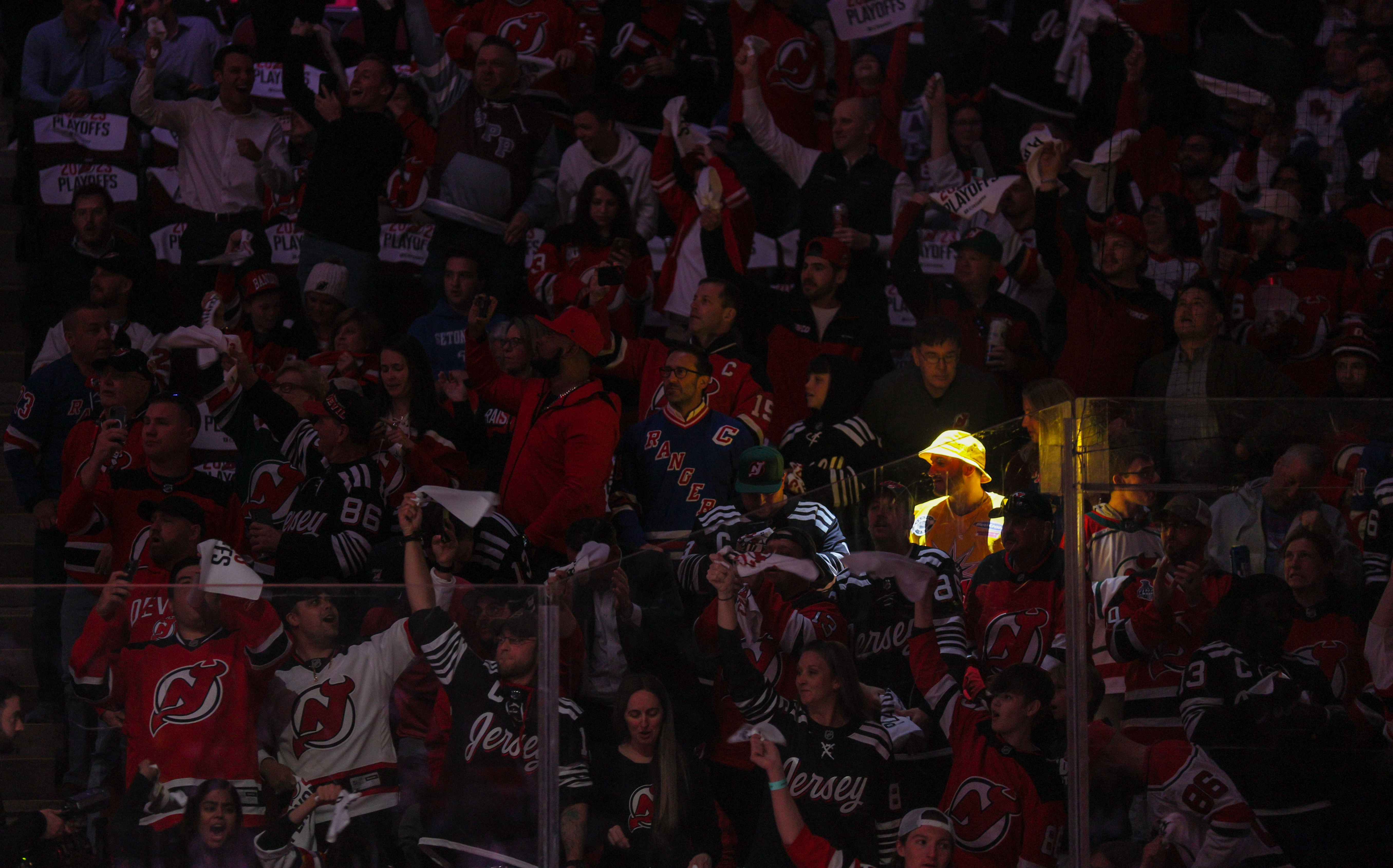 Fans in the lower level of Prudential Center wave towels as they wait for players to take the ice for Game 1 of the Stanley Cup playoffs series between the New Jersey Devils and the New York Rangers on Tuesday, April 18, 2023 in Newark, N.J. 