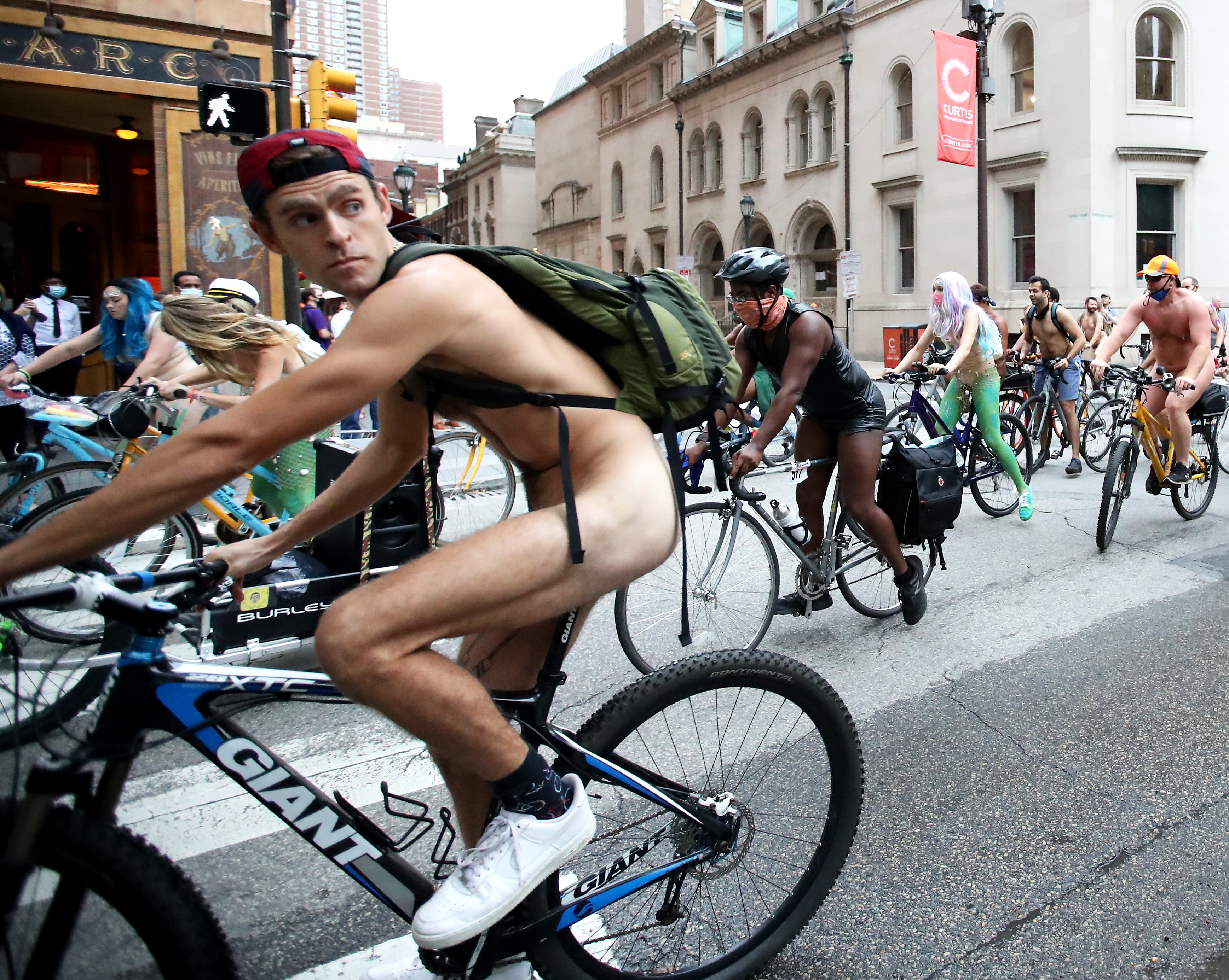 People ride bikes around Rittenhouse Square in Philadelphia during the Philly Naked Bike Ride, Saturday, Aug. 28, 2021.