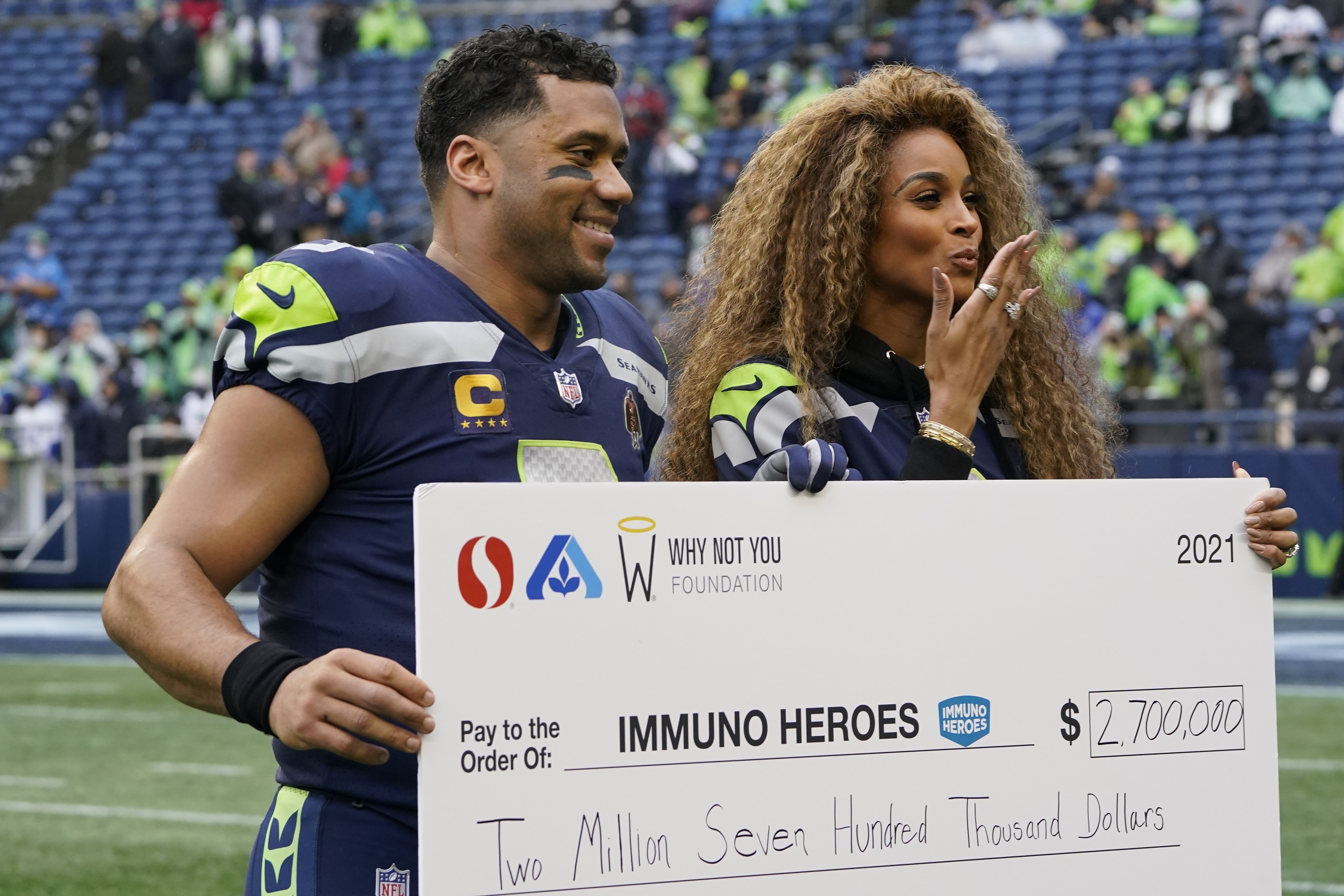 Seattle Seahawks quarterback Russell Wilson and wide receiver DK Metcalf  celebrate a touchdown during an NFL football game against the Detroit  Lions, Sunday, Jan. 2, 2022, in Seattle. The Seahawks won 51-29. (