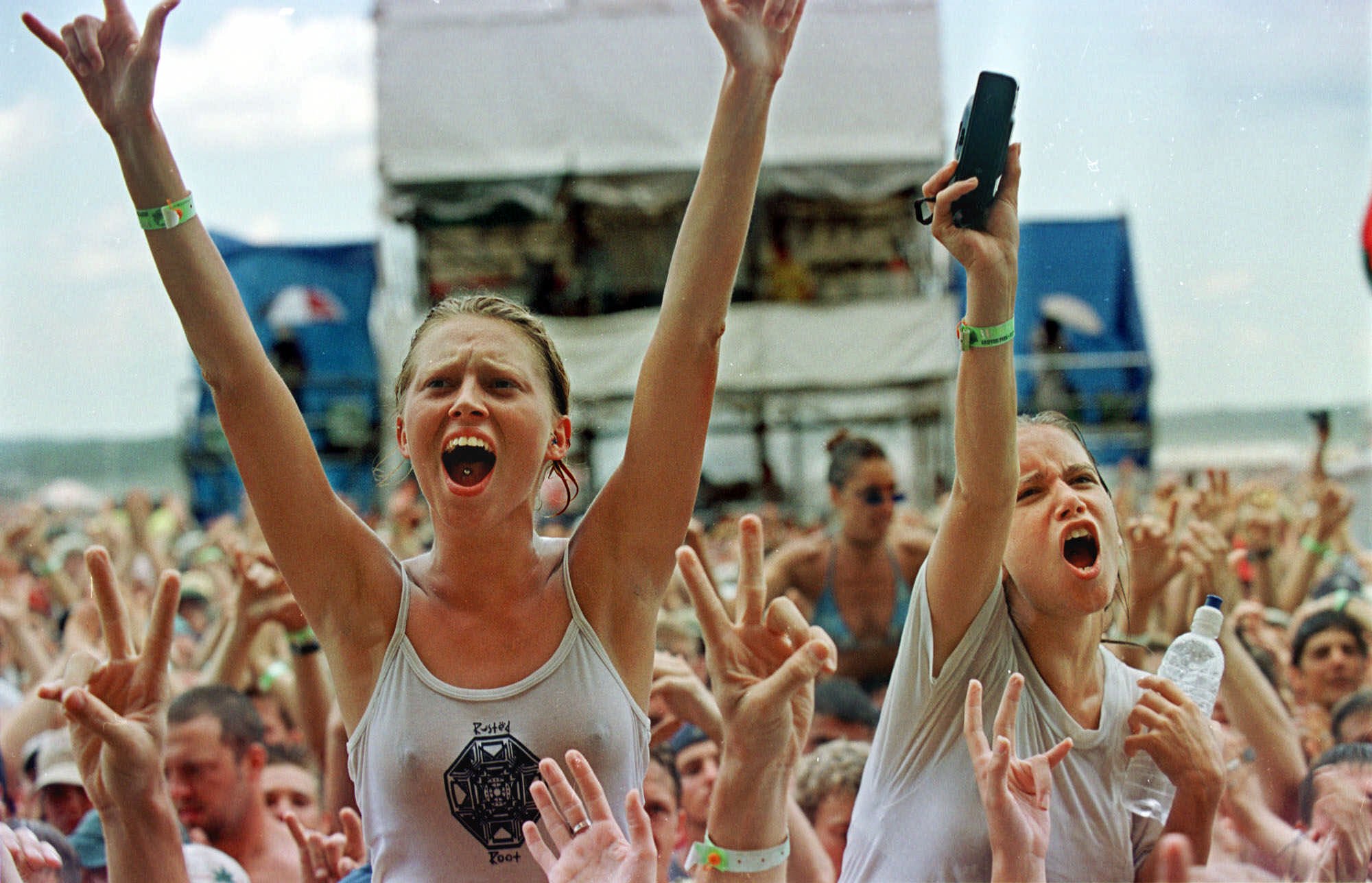 Fans cheer as Rusted Root performs on the final day of Woodstock '99 S...