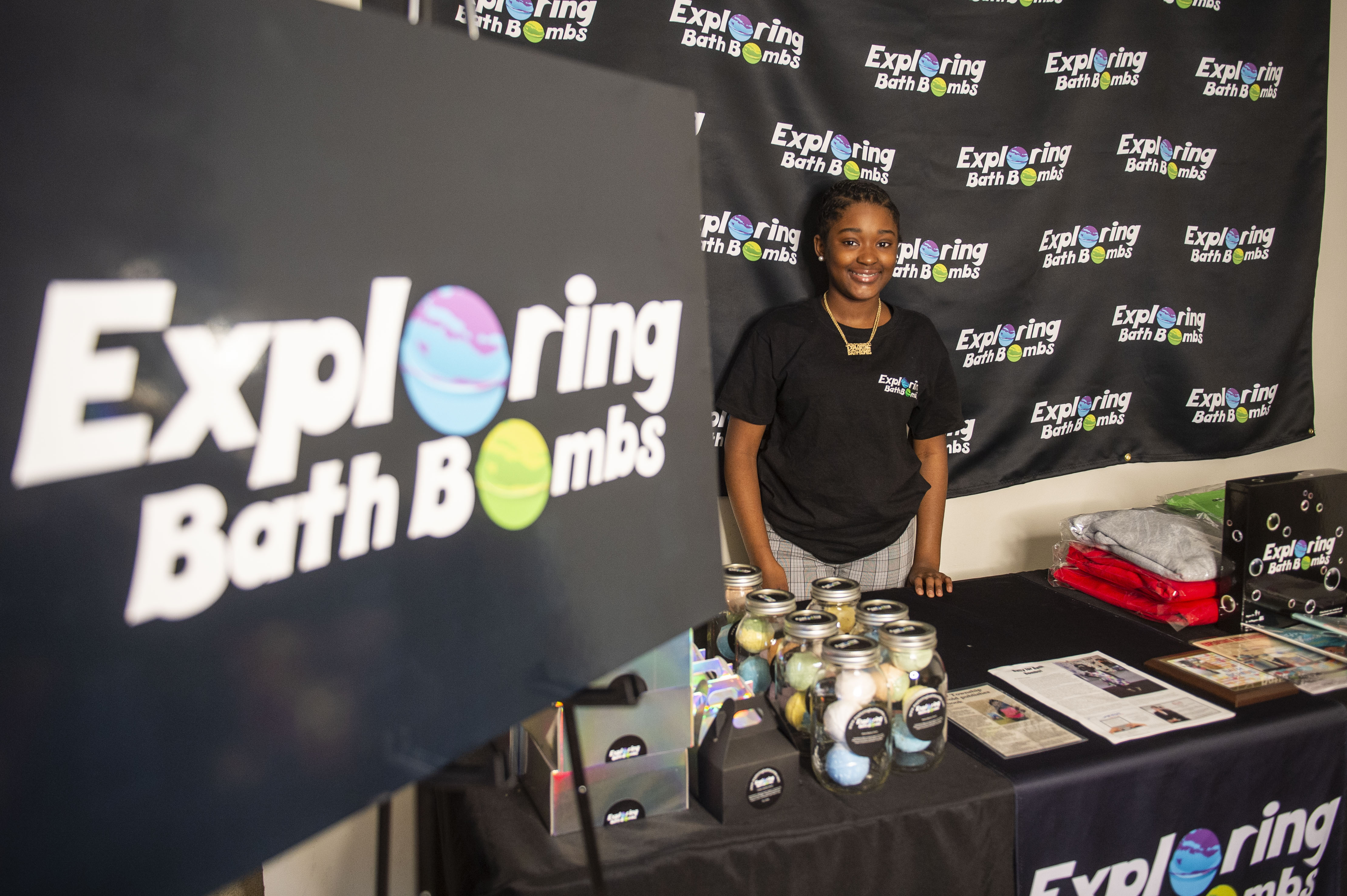 Sa'Veya Jackson, 11, poses for a photograph with products from her business Exploring Bath Bombs on Thursday, April 22, 2021. (Kaytie Boomer | MLive.com)