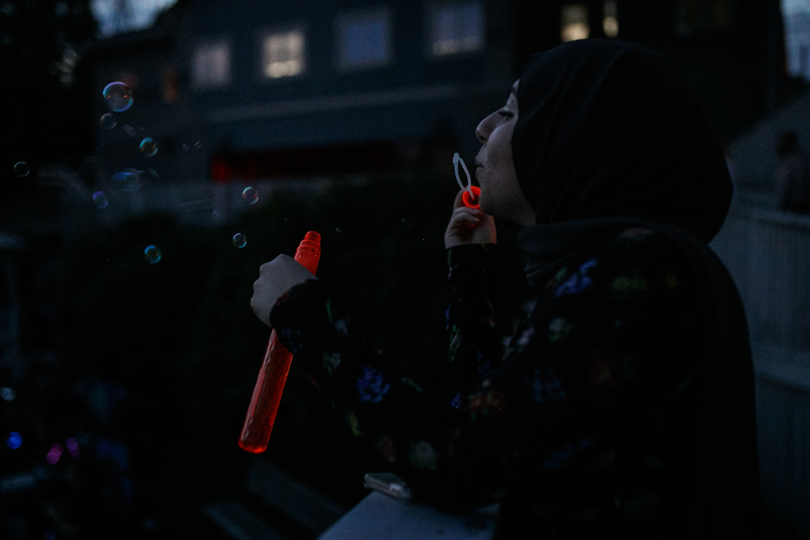 Saafa Tahboub blows bubbles while waiting for the start of the annual Lake Fenton Fireworks on the water in front of the Township hall on Saturday, June 2, 2022 in Fenton Township. (Jenifer Veloso | MLive.com)

