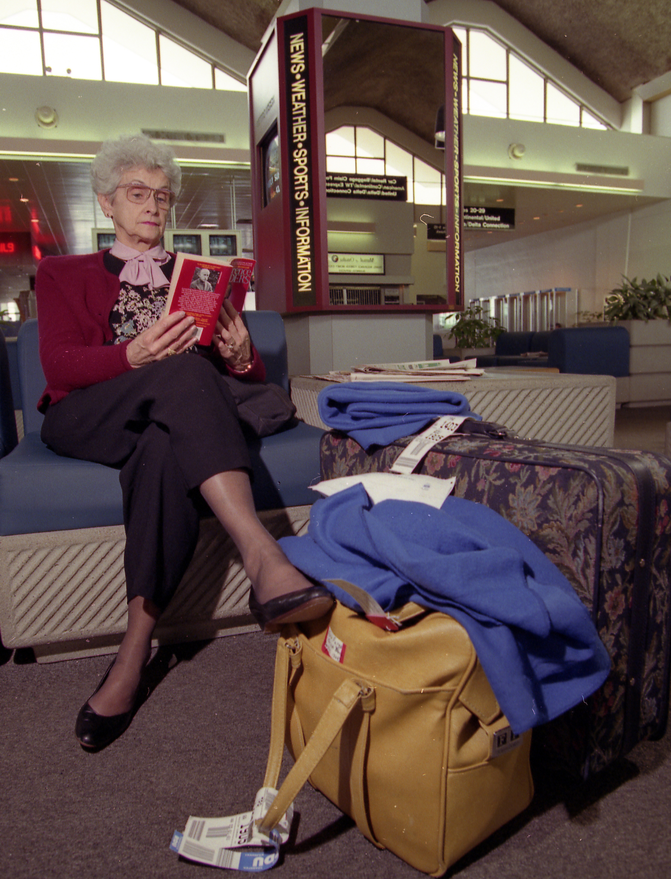 Mary Fern Fargo, from Great Bend, NY, reads at Hancock Airport while waiting for the airport to reopen during snowstorm of March 13 and 14, 1993.