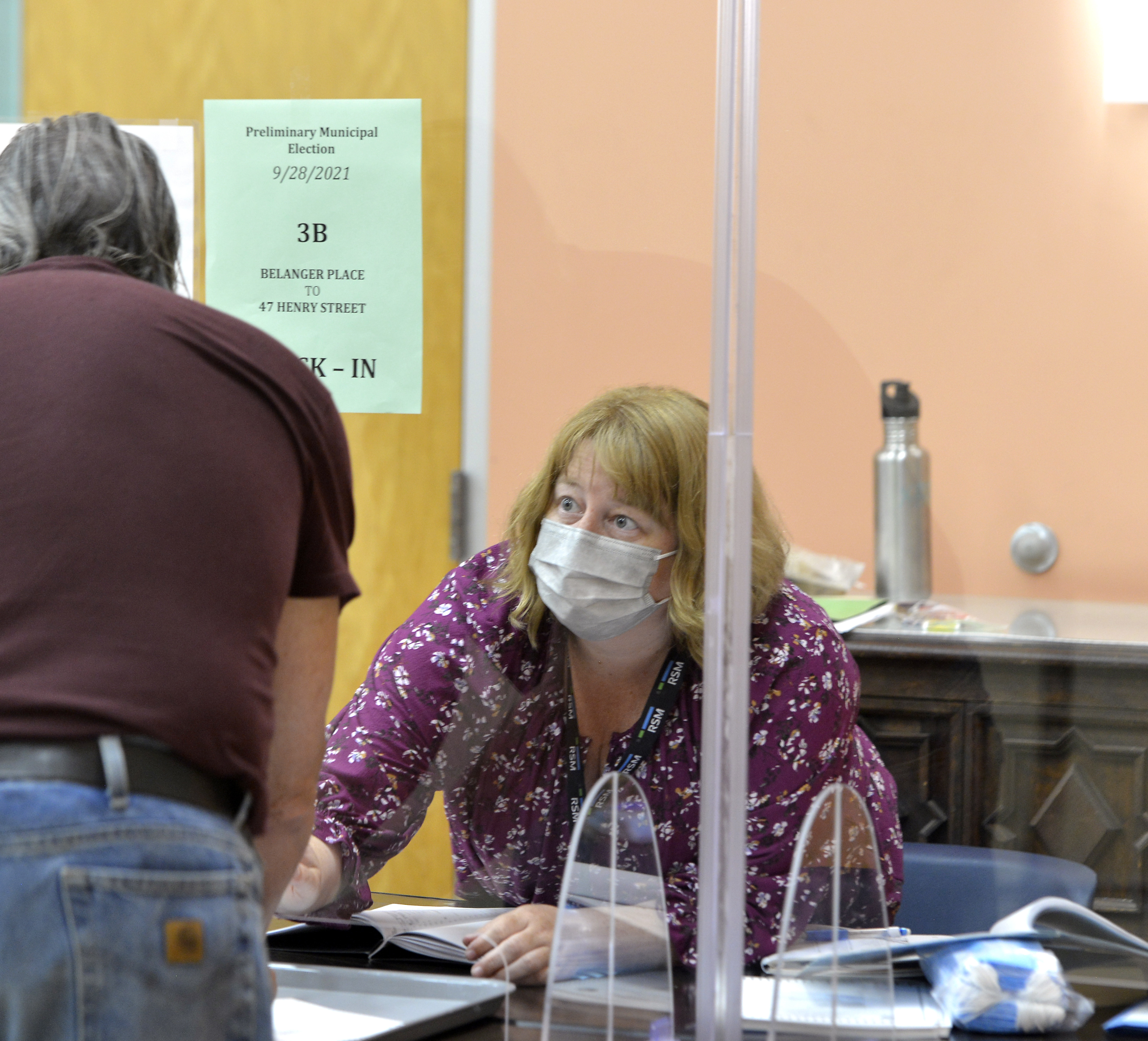 Election worker Jessica Neiswender assists a voter during perliminary election voting at the Northampton Senior Center, Sptember 28, 2021.   (Don Treeger / The Republican)