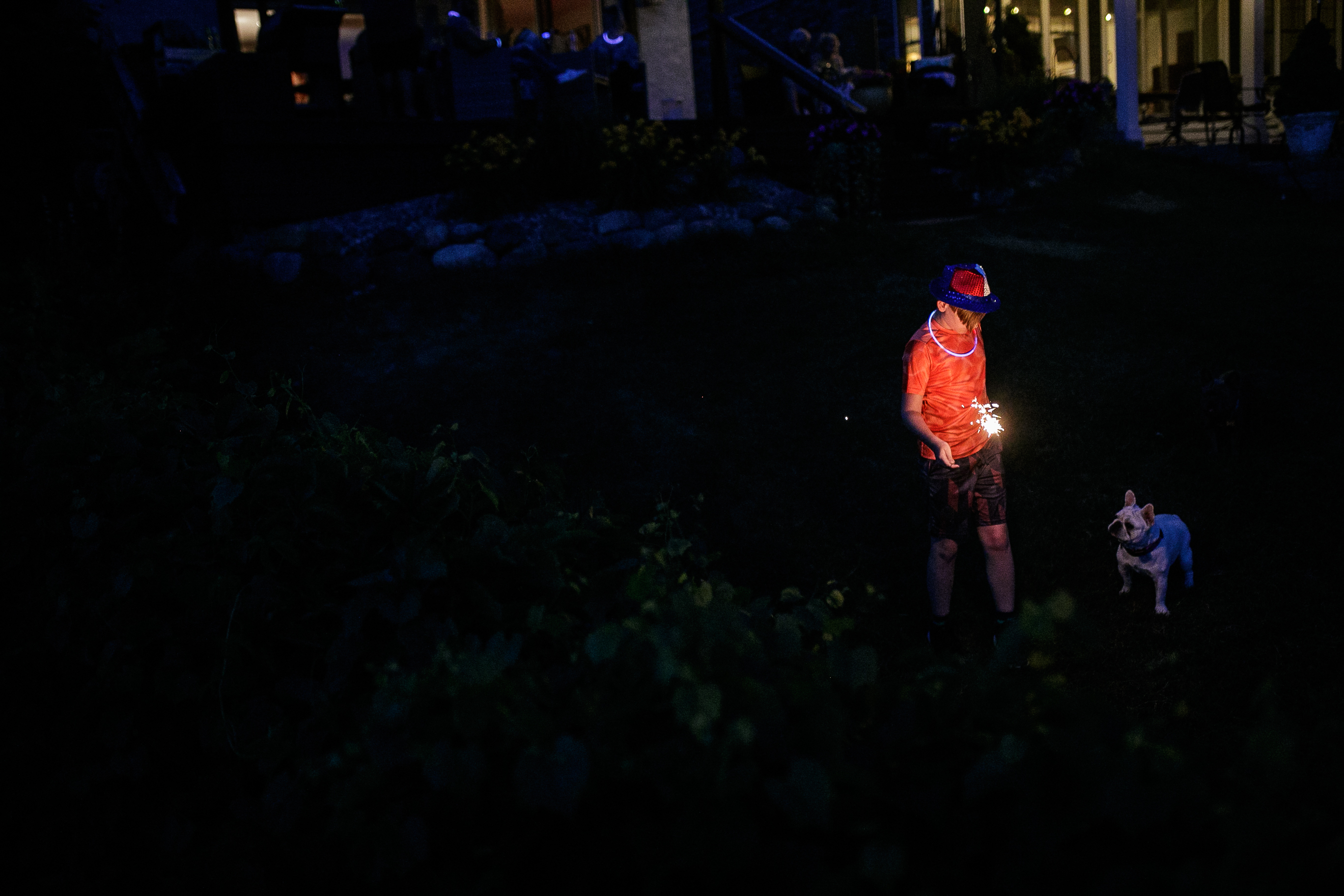 A little boy and his dog play with a sparkler in his backyard before the annual Lake Fenton Fireworks on the water in front of the Township hall on Saturday, June 2, 2022 in Fenton Township. (Jenifer Veloso | MLive.com)


