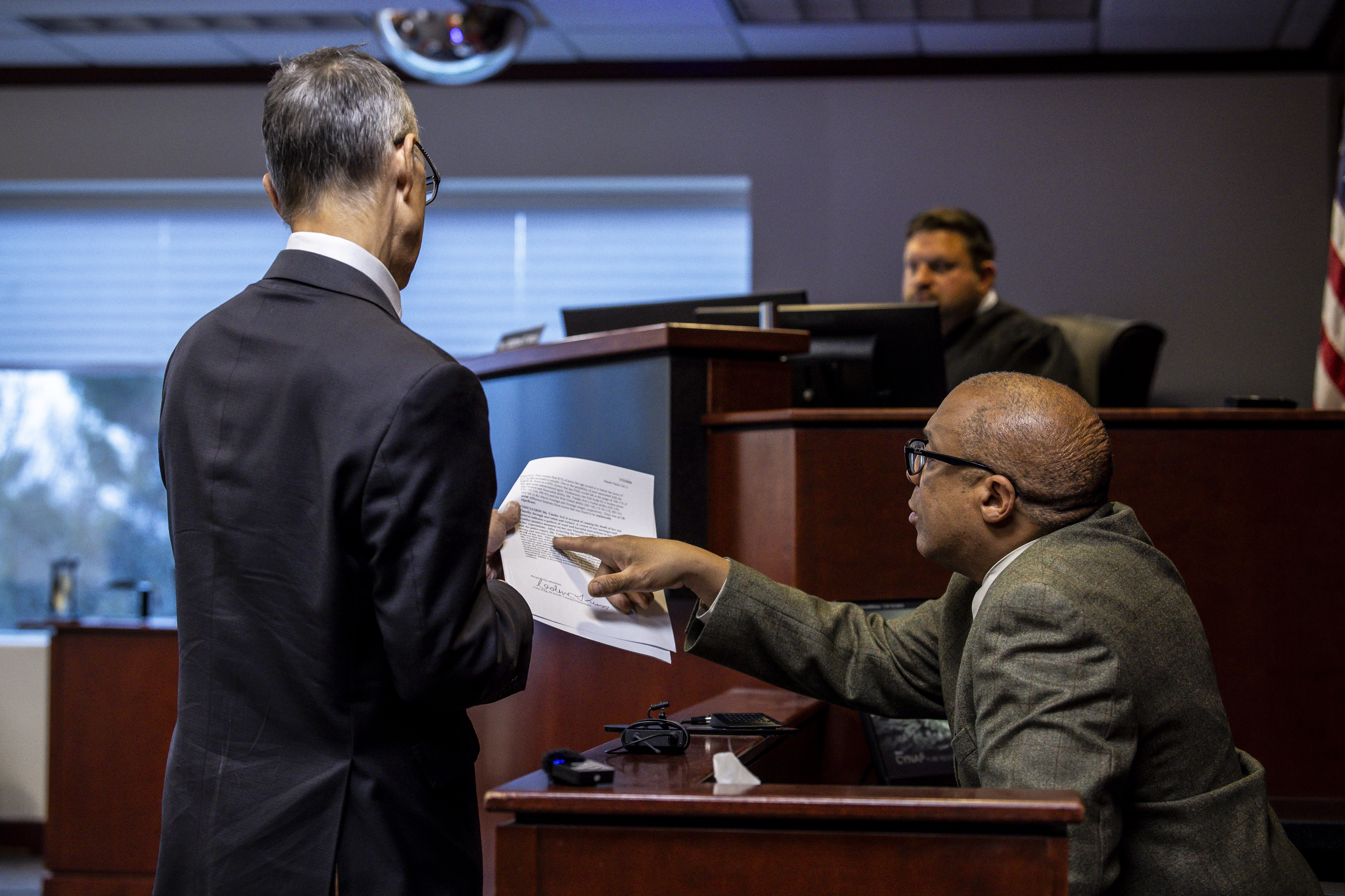 Attorney Ronald D. Ambrose, left, provides a transcript to trial attorney Fred Johnson takes the stand as former client Shanda Vander Ark, the mother convicted of torturing her 15-year-old son to death, appears in court for a Ginther hearing seeking a new trial at Muskegon County Circuit Court in Muskegon, Mich. on Tuesday, November 25, 2025. Vander Ark’s defense claims she was in a “catatonic state” throughout her trial that featured disturbing testimony of how she inflicted cruel punishments on her son, Timothy Ferguson, leading to the boy’s death.