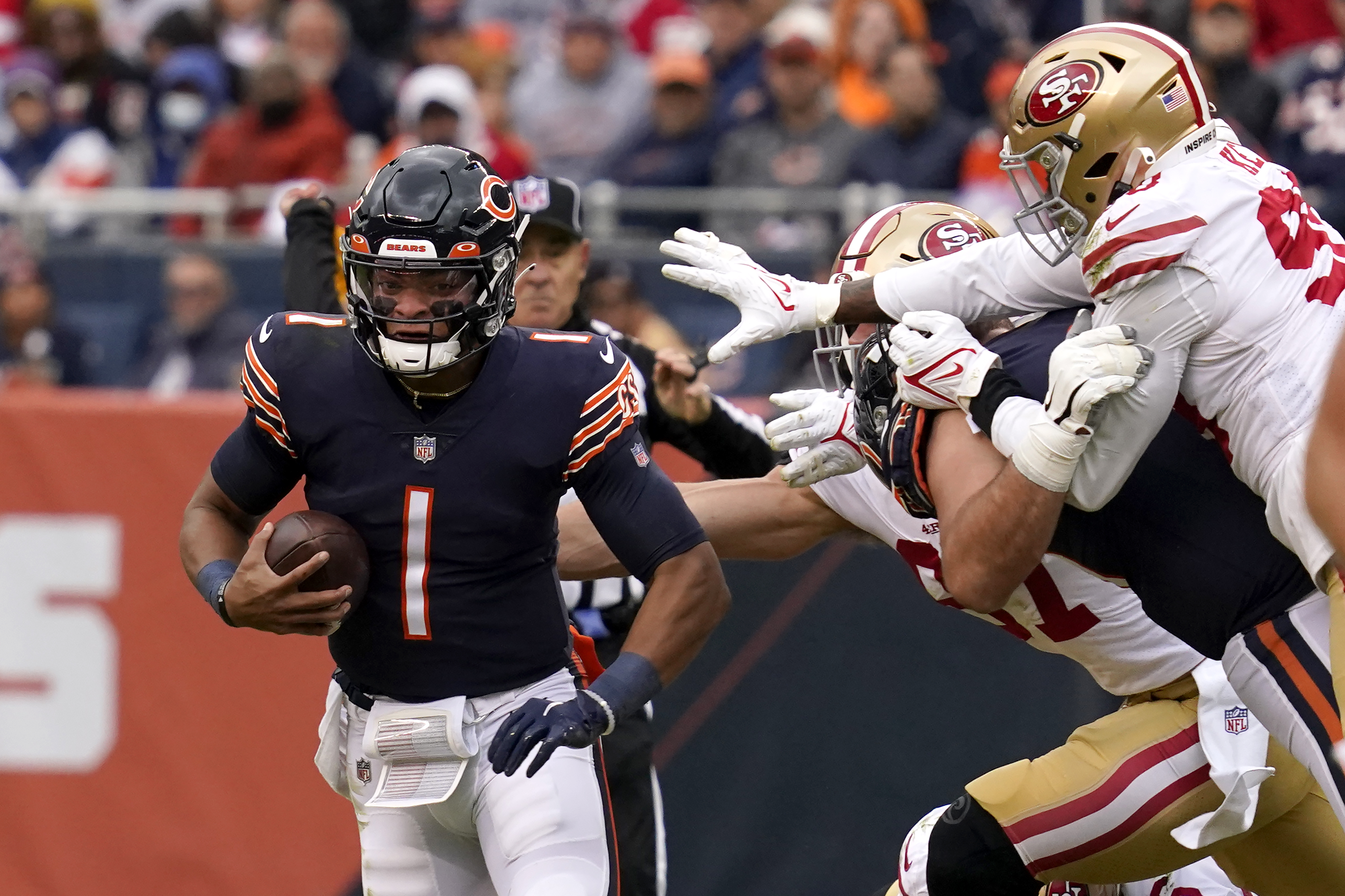 Chicago Bears quarterback Justin Fields runs against the