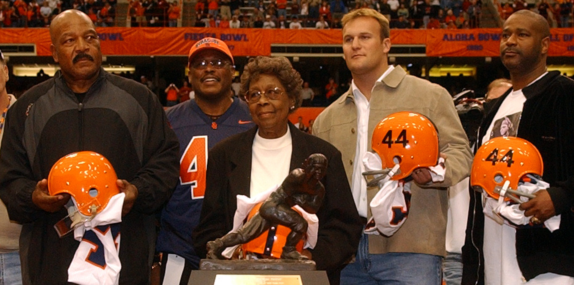 Marie Fleming, mother of Ernie Davis, stands with  Jim Brown, Floyd Little, Rob Konrad and Michael Owens during a 2005 retirement ceremony of the jersey number 44 at the Carrier Dome.
