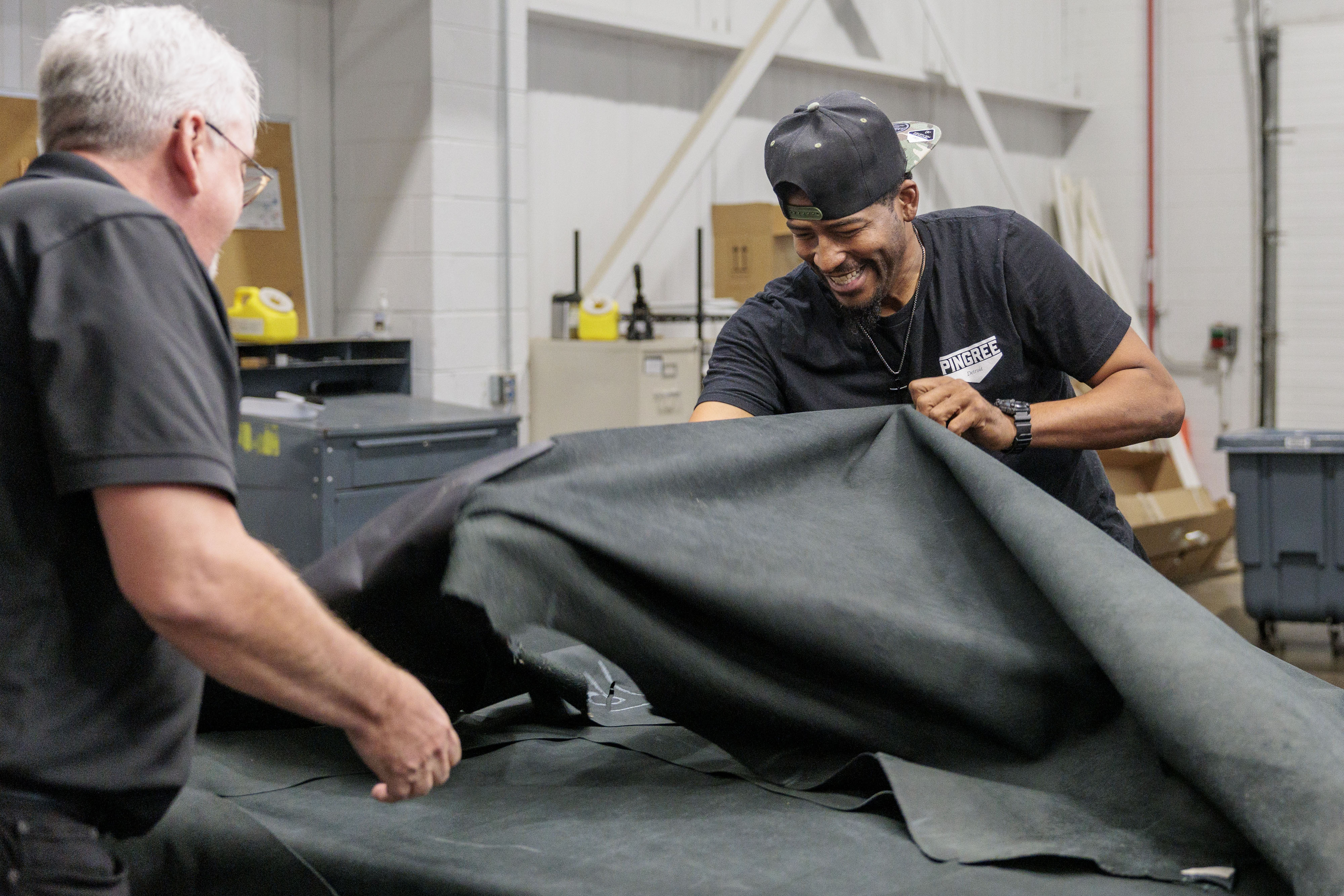Nathaniel Crawford II, Co-Owner and Vice President of Footwear Operations at Pingree Detroit, sorts through donated automotive leather at Pangea in Rochester Hills on Monday, Oct. 6 2025.
