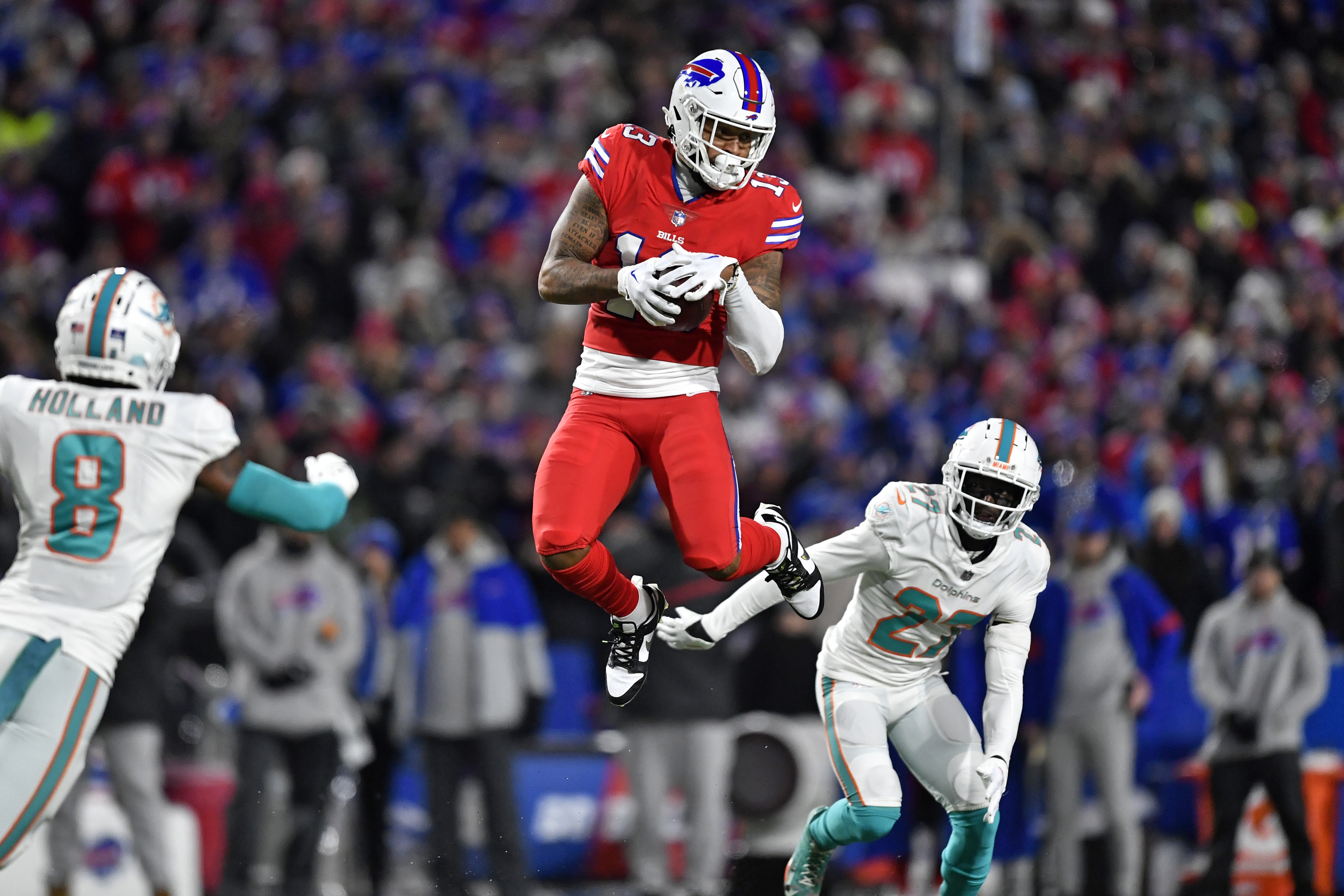 Miami Dolphins wide receiver Jaylen Waddle (17) catches a pass Buffalo  Bills cornerback Tre'Davious White (27) during second quarter of an NFL  football game at Highmark Stadium on Saturday, Dec. 17, 2022