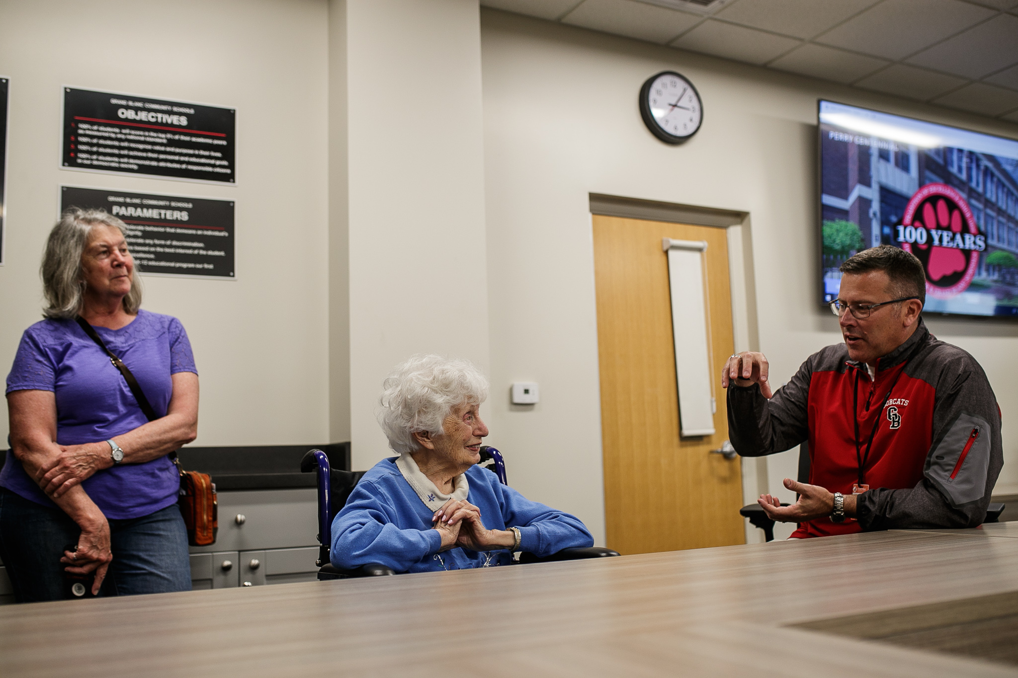 Grand Blanc Schools Superintendent Trevor Alward speaks with oldest living graduate Mary Evatt Gainor during the Perry Center Centennial Event in Grand Blanc on Saturday, May 14, 2022. (Jenifer Veloso | MLive.com)
