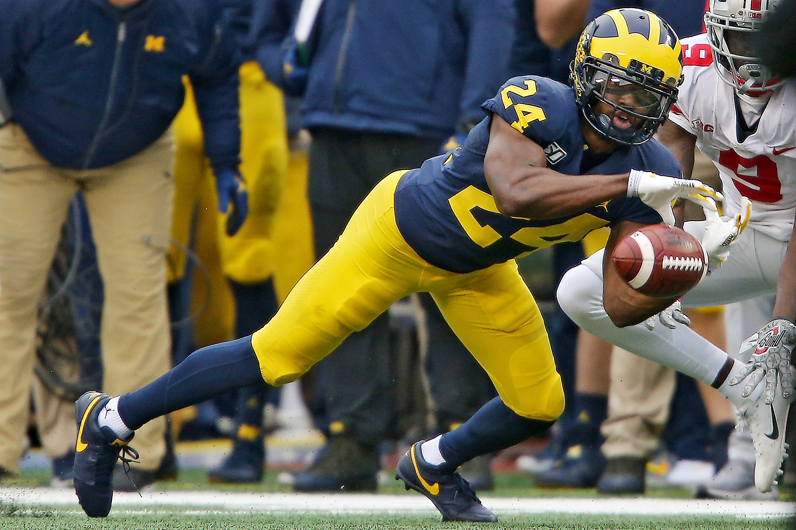 Michigan defensive back Lavert Hill (24) celebrates his interception with  linebacker Khaleke Hudson, right, in the second quarter of an NCAA college  football game against Iowa in Ann Arbor, Mich., Saturday, Oct.