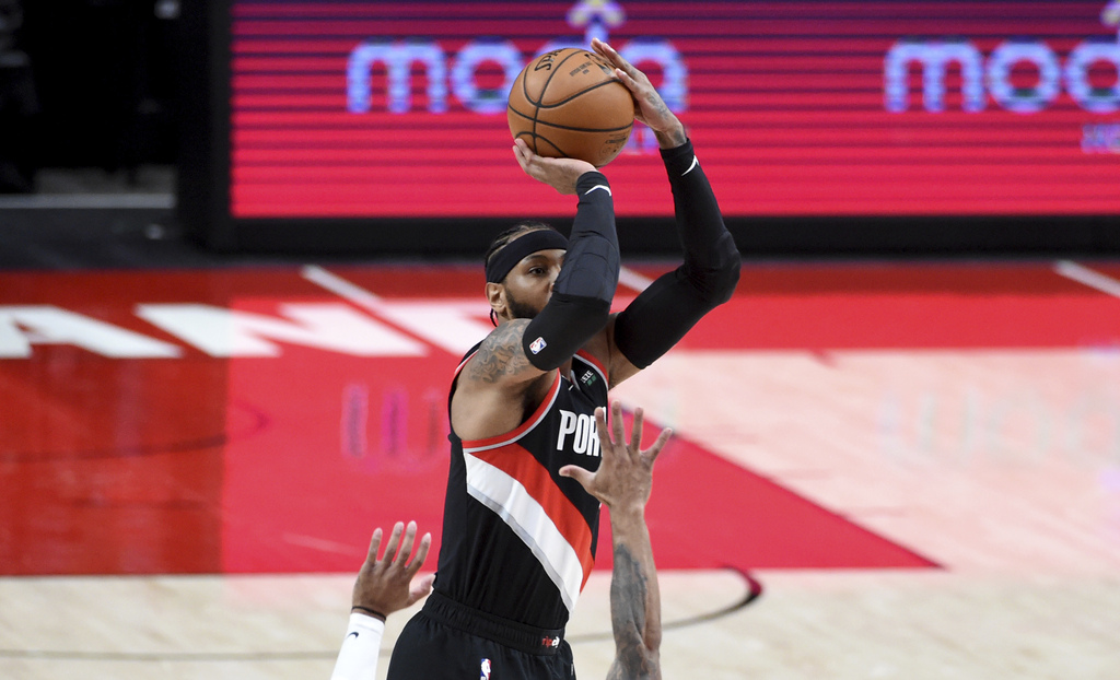 Portland Trail Blazers power forward Carmelo Anthony (00) reacts after a  shot against the Milwaukee Bucks during the first half at Moda Center.