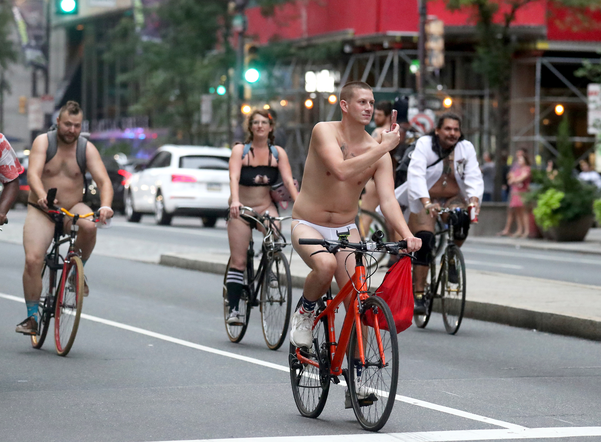 People ride bikes down South Broad Street in Philadelphia during the Philly Naked Bike Ride, Saturday, Aug. 28, 2021.
