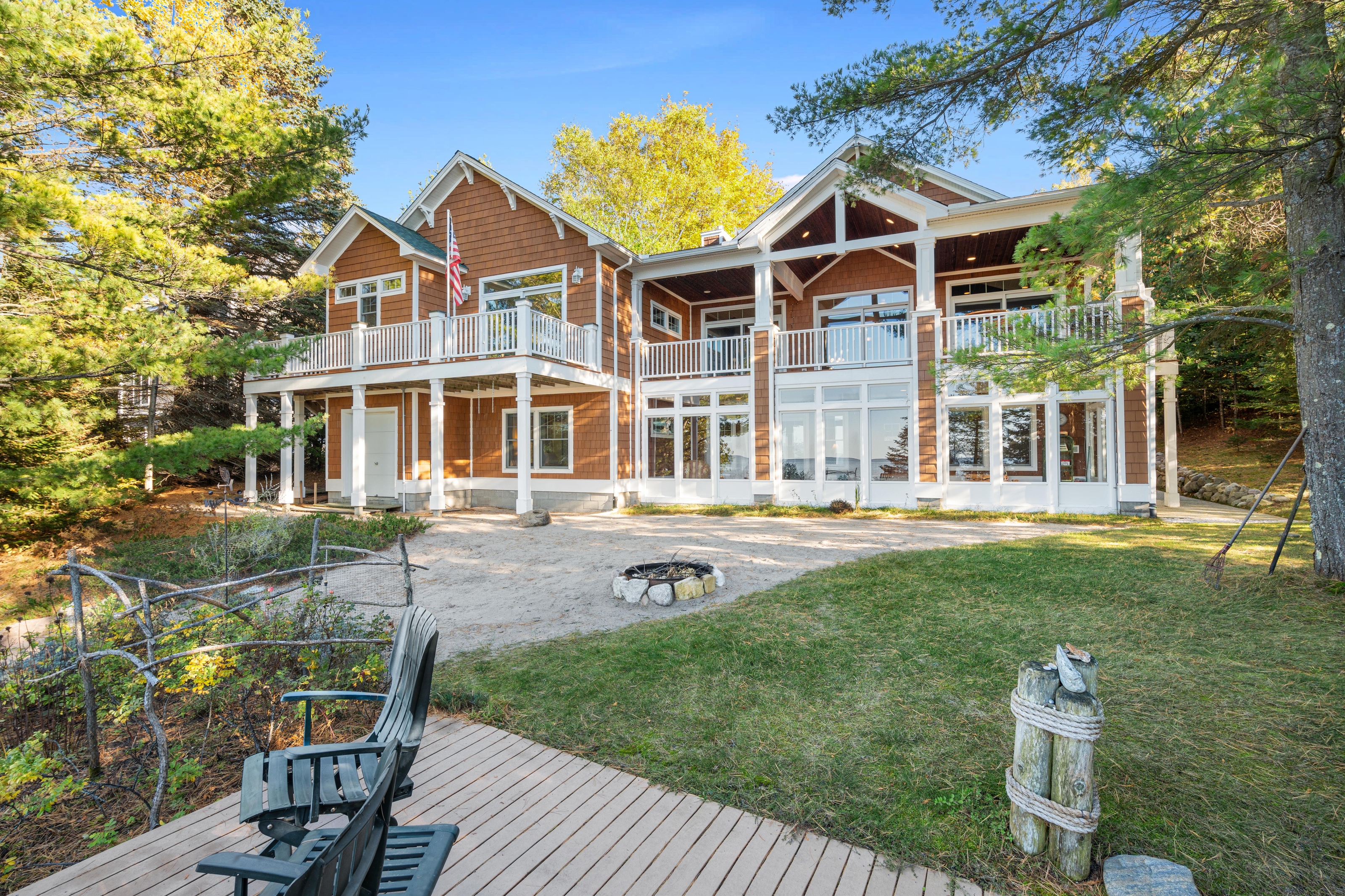 Exterior photographs of 4093 Lake Shore Drive in Charlevoix, this gem is listed at $2,099,900 through Berkshire Hathaway HomeServices Michigan Real Estate – Traverse City and The Crane Group with associate broker Johnny Crane and his brother, co-listing agent Matt Crane.