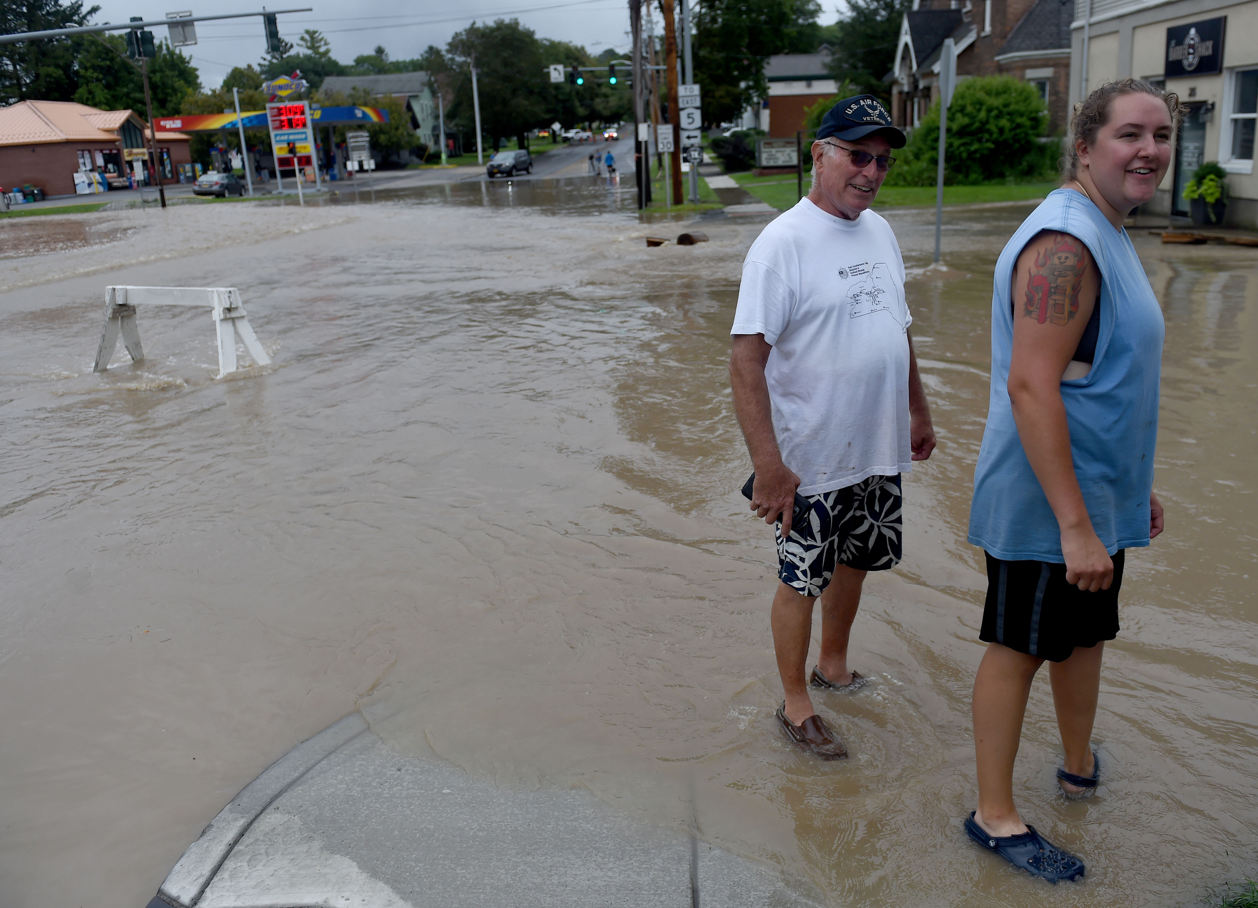 Jim Goodwin and Ashley Rether, residents on South Street in Camillus, survey the flooding of Ninemile Creek August 19, 2021. Goodwin says he hasn't seen anything like this in the village since 1971. Heavy rains again created flooding in Central New York with a lot of flooding occurring along Ninemile Creek in Camillus and Marcellus. Dennis Nett | dnett@syracuse.com
