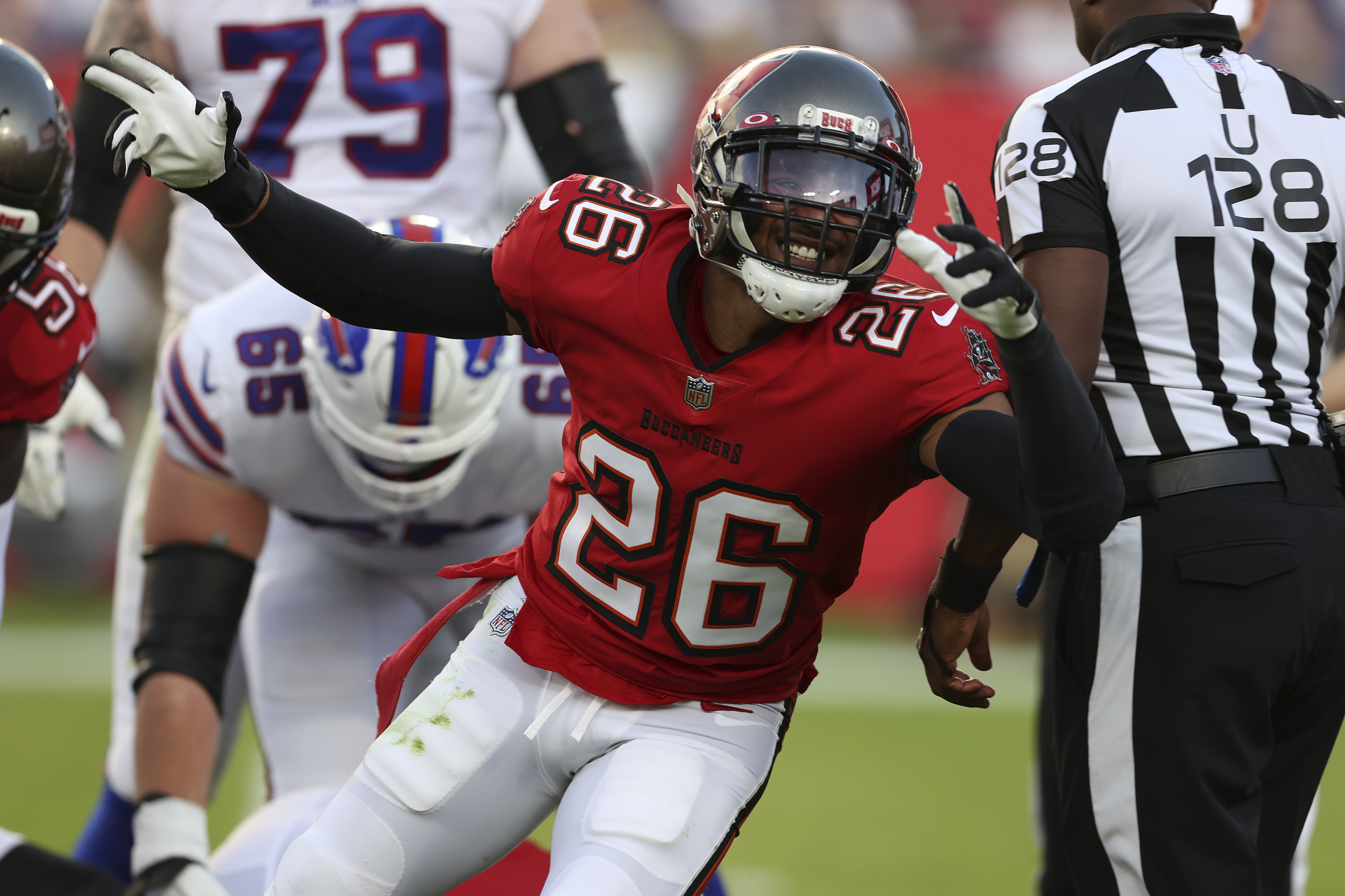 Tampa Bay Buccaneers safety Andrew Adams (26) grabs Buffalo Bills  quarterback Josh Allen (17) b …