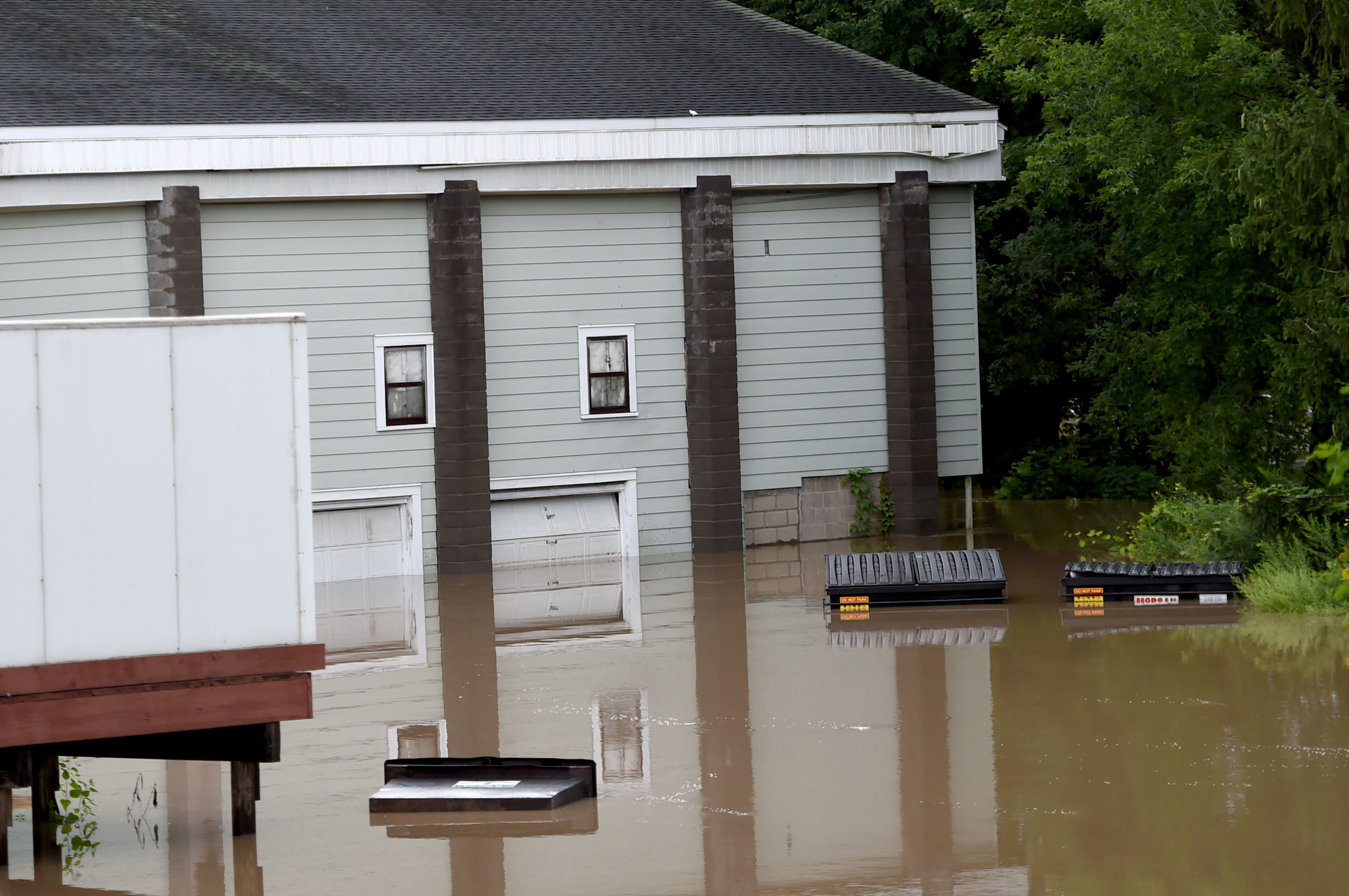 Flooding from Ninemile Creek nearly tops the dumpsters at a restaurant on Newport Road in Camillus August 19, 2021. Heavy rains again created flooding in Central New York with much of the flooding occurring along Ninemile Creek in Camillus and Marcellus. Dennis Nett | dnett@syracuse.com