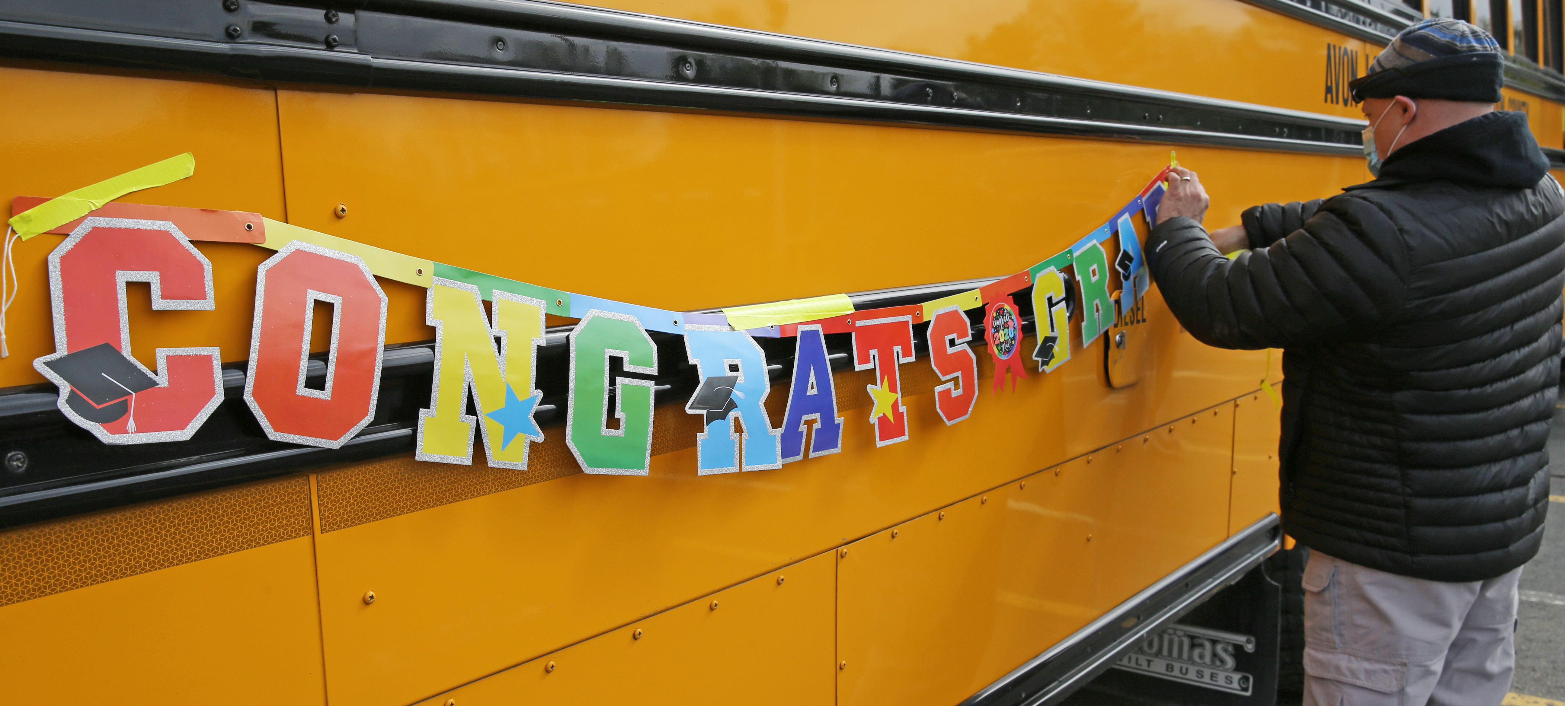 Avon High School uses school buses to deliver senior graduation signs ...