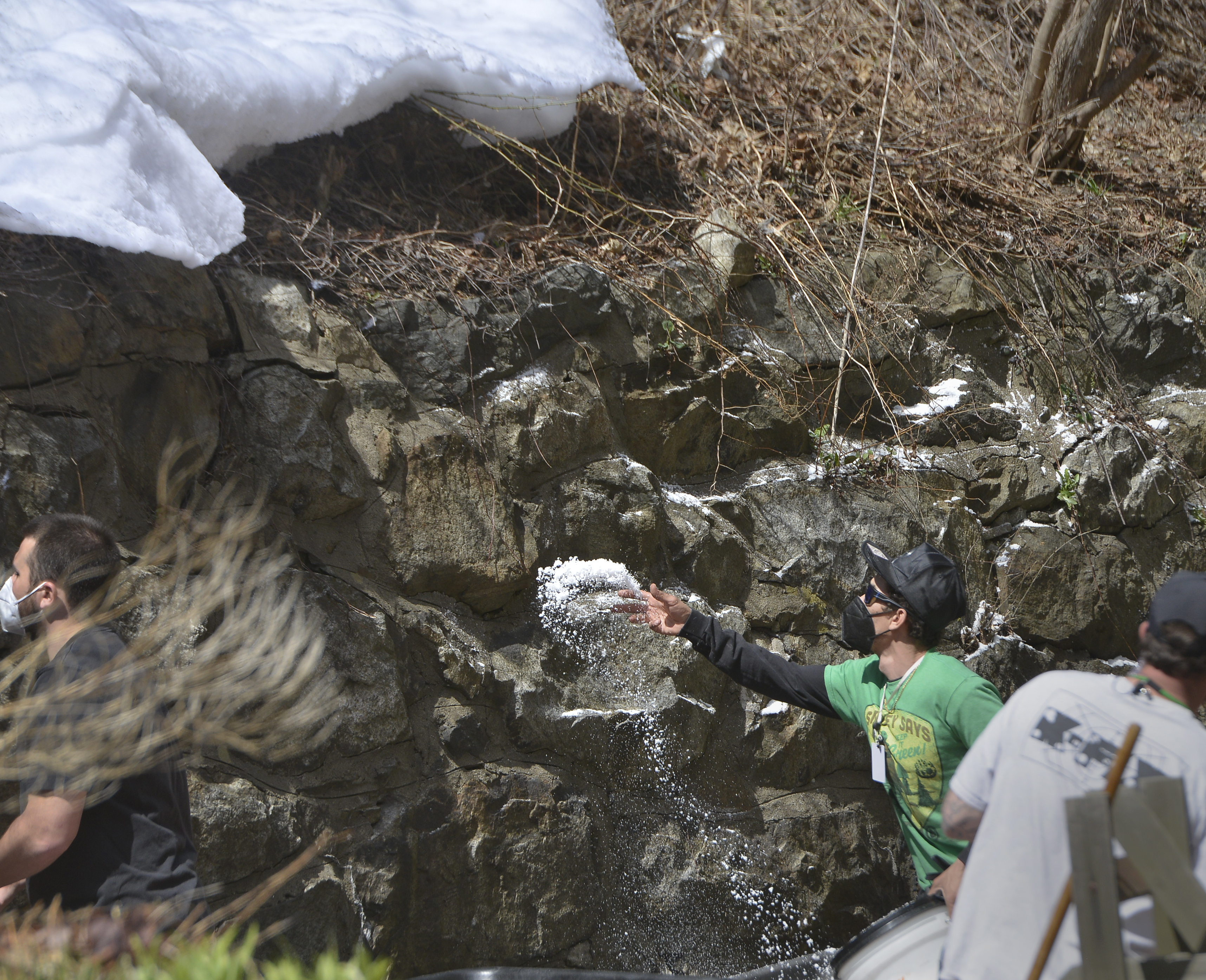 Fake snow is tossed onto what will be the backround for a scene in the show Dexter, now being filmed in downtown Shelburne Falls, April 7, 2021.  (Don Treeger / The Republican)