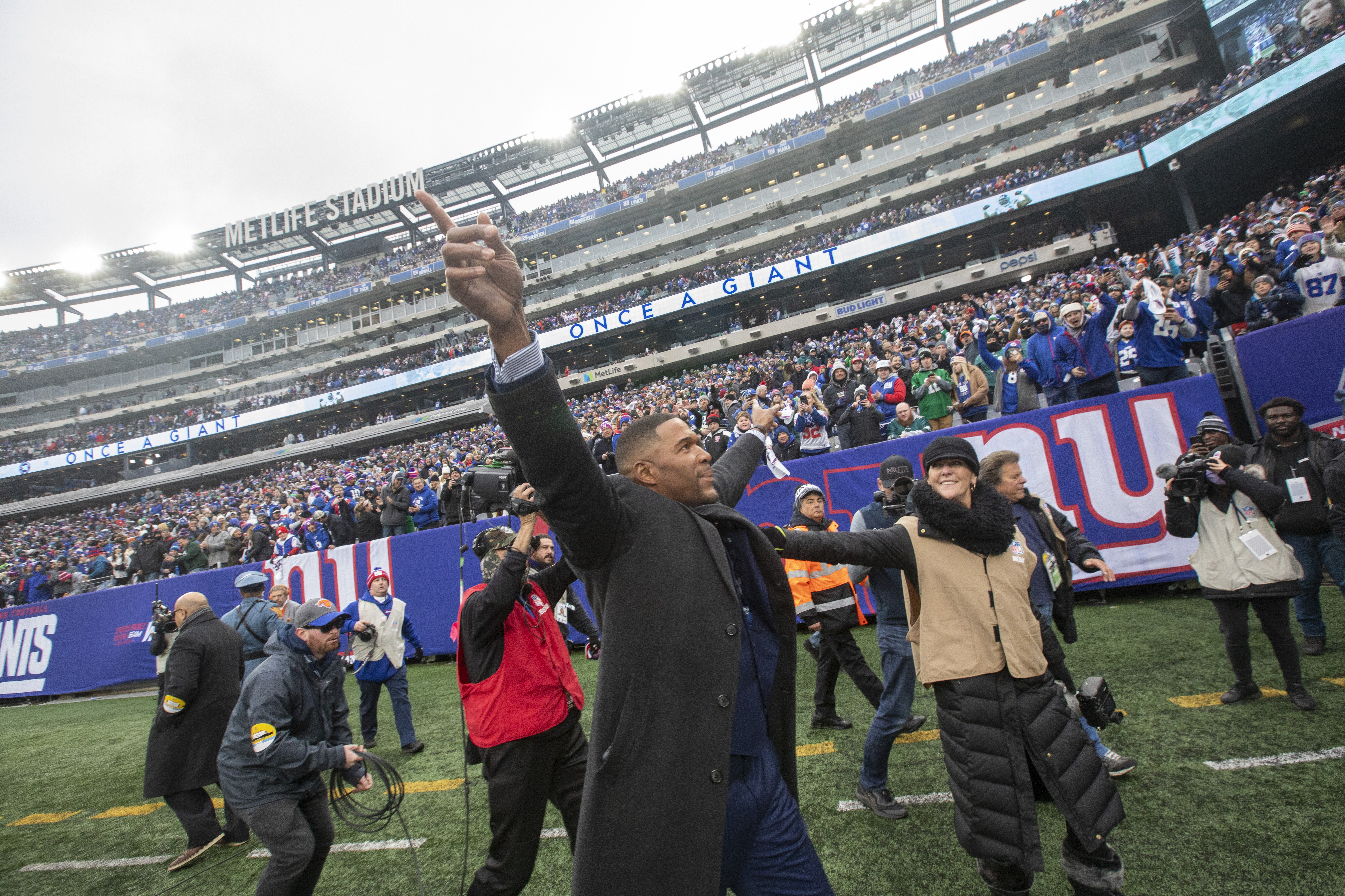 Former New York Giants great Michael Strahan waves to the crowd during a halftime ceremony to retire Strahan’s No. 92 jersey on Sunday, Nov. 28, 2021 at MetLife Stadium.