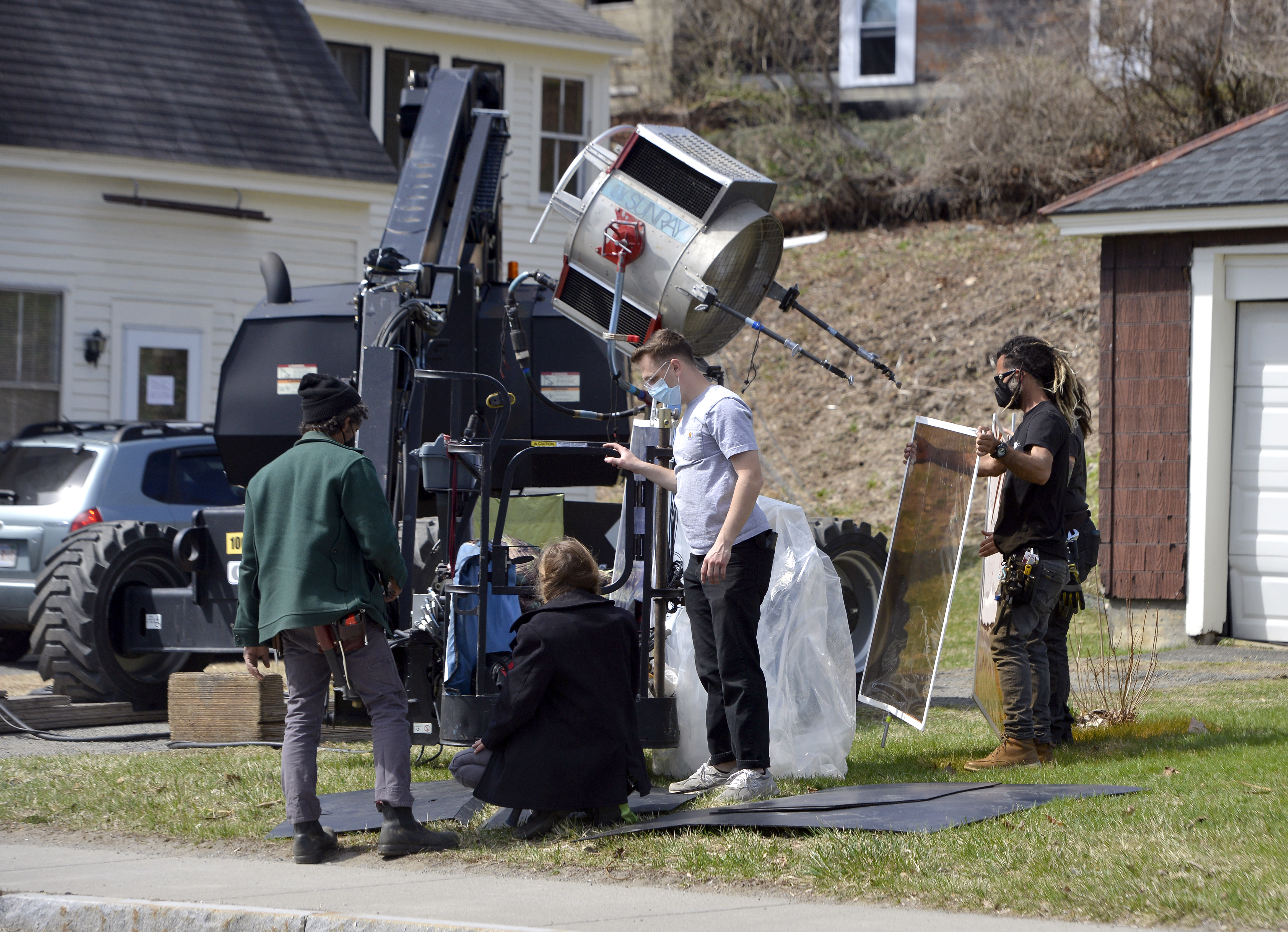 Crew members work on lighting equipment along State Street in Shelburne Falls as an episode of the show Dexter is filmed in town, April 7, 2021.   (Don Treeger / The Republican)