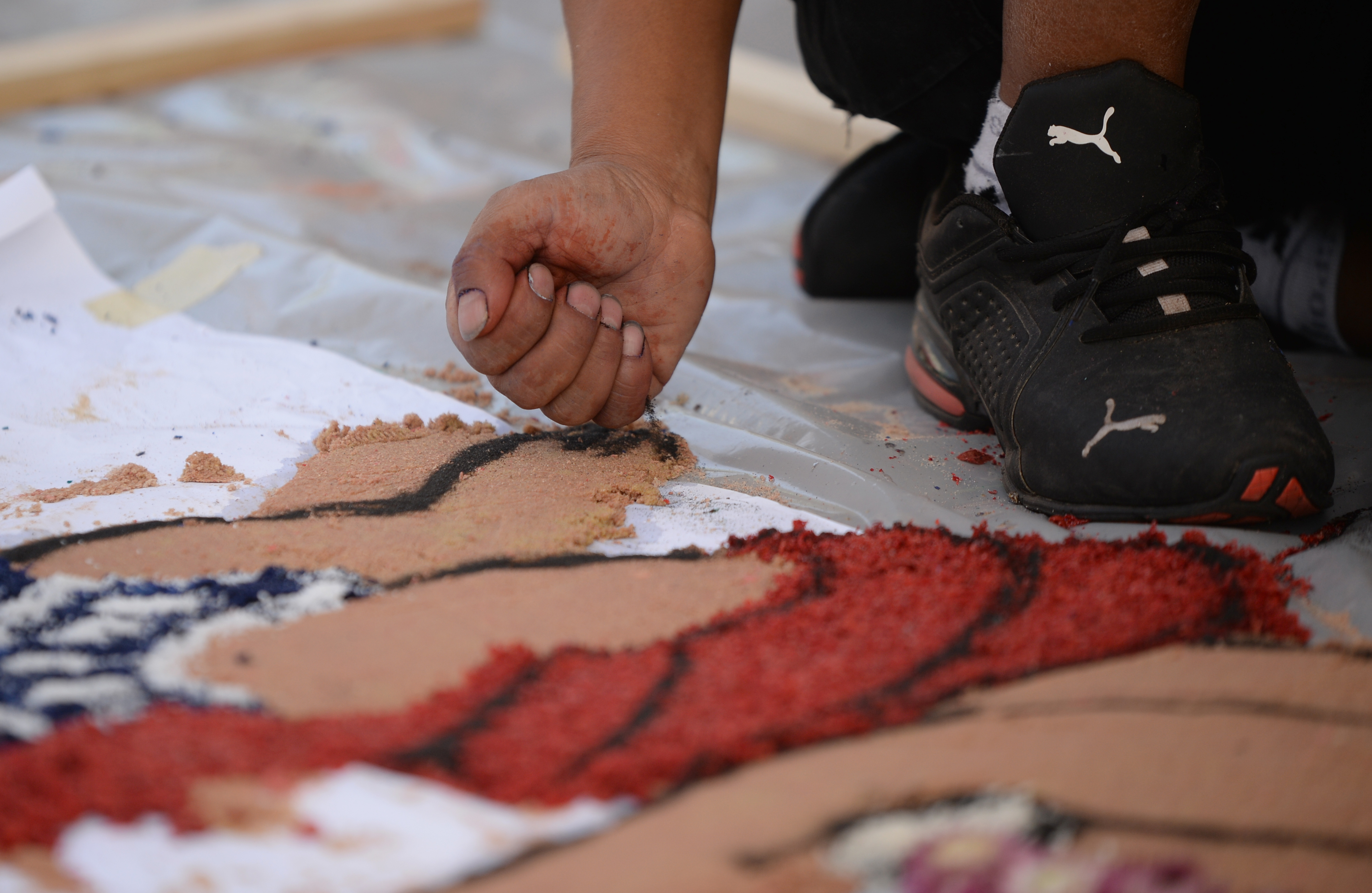 Guatemalan artist Ubaldo Sánchez creates a sawdust carpet during the 22nd annual Festival of Fine Craft at Wheaton Arts in Millville, Saturday, Oct. 2, 2021.