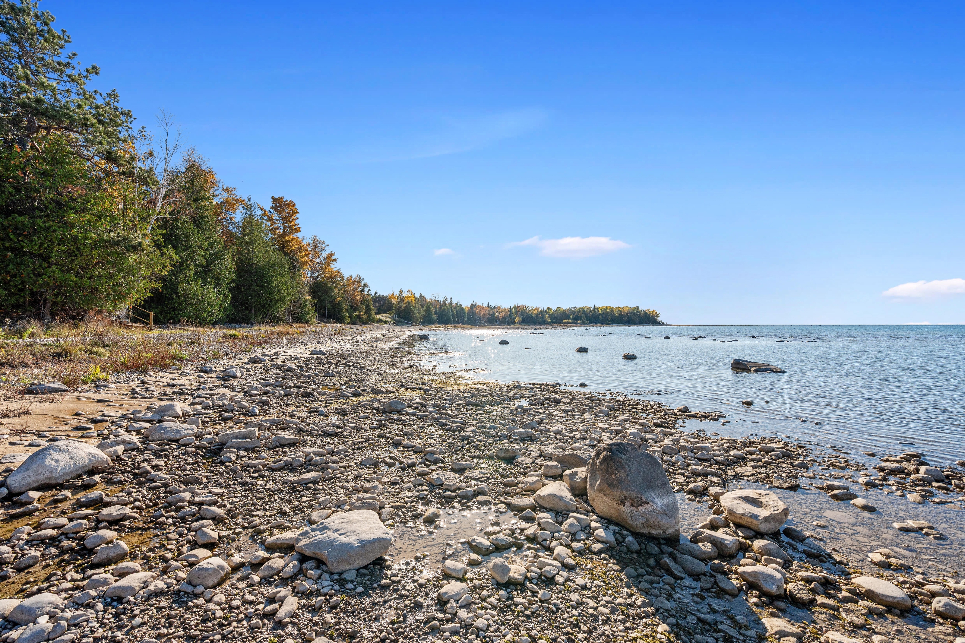 Exterior photographs of 4093 Lake Shore Drive in Charlevoix, this gem is listed at $2,099,900 through Berkshire Hathaway HomeServices Michigan Real Estate – Traverse City and The Crane Group with associate broker Johnny Crane and his brother, co-listing agent Matt Crane.