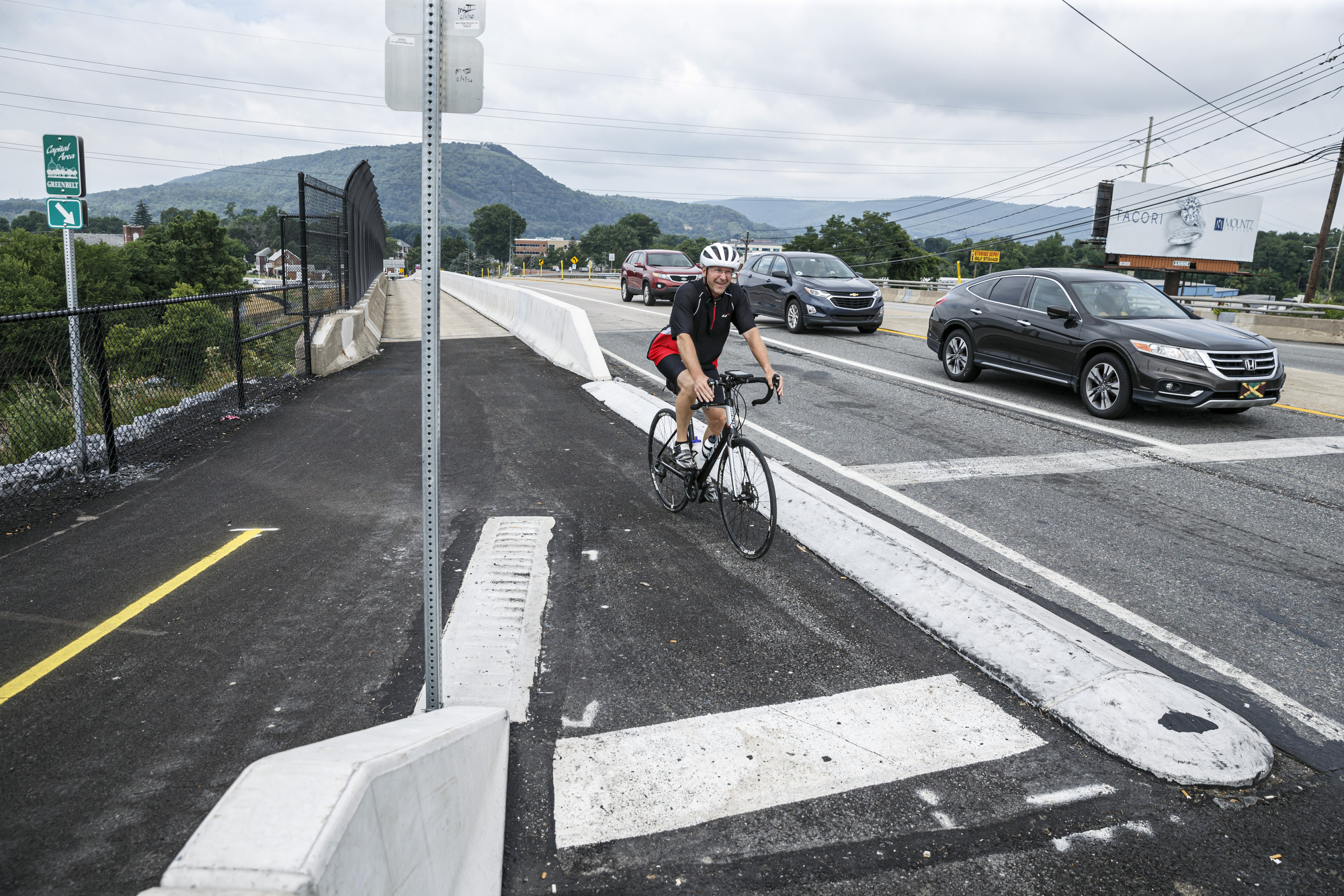 A bicyclist rides is the Greenbelt trail extension at the intersection of Industrial Road and Linglestown Road, near Wildwood Park. The Capital Area Greenbelt Fort Hunter 2-mile connector has been finished. The extension connects the 20-mile Greenbelt between Fort Hunter Park and the northernmost part of the Greenbelt at Lingletstown Road at Wildwood Park.July 17, 2020. Dan Gleiter | dgleiter@pennlive.com