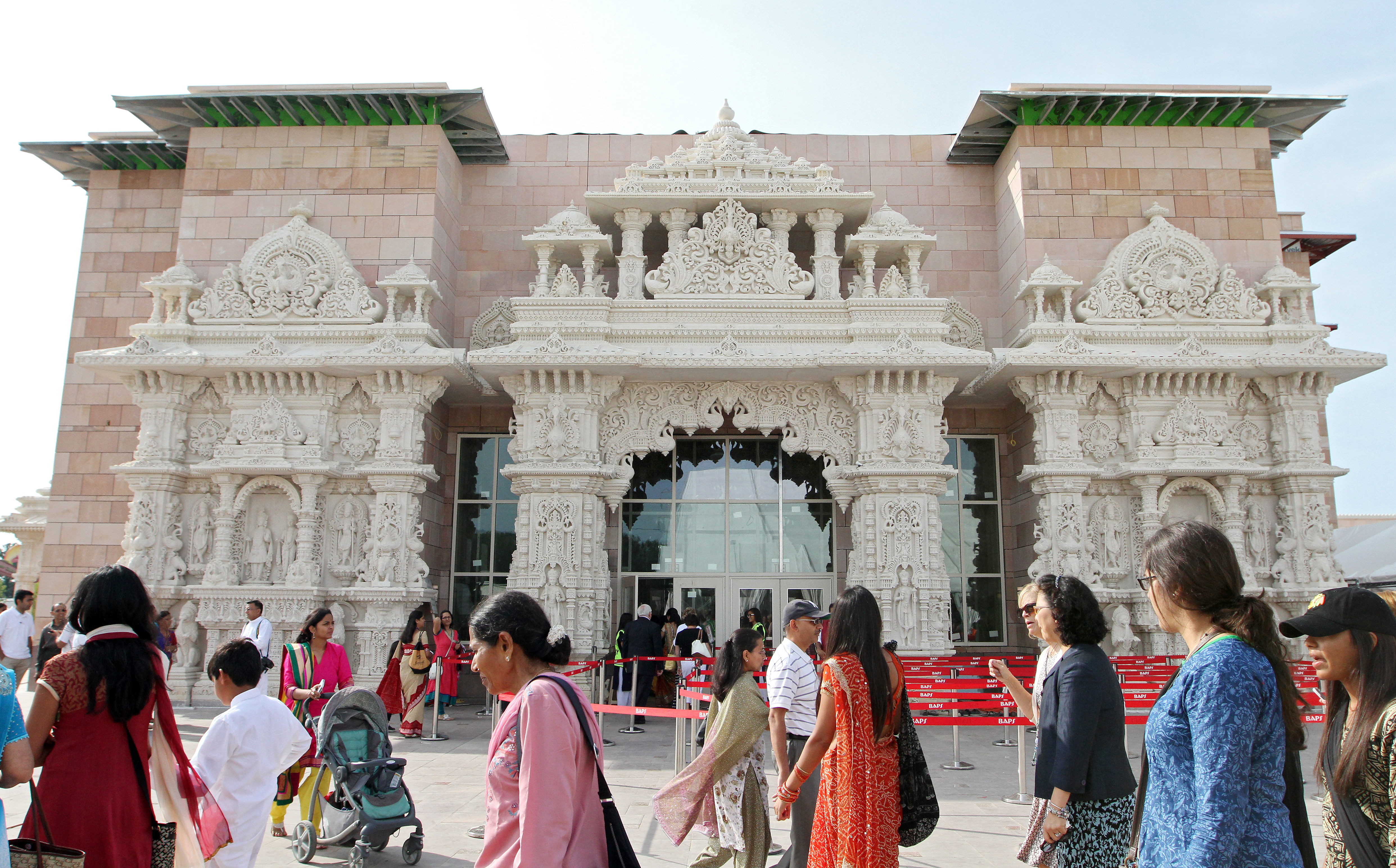 Visitors walk outside the new BAPS Shri Swaminarayan Mandir temple in Robbinsville. The exterior is decorated with images of deities made from limestone. The temple officially open Saturday, August 16, 2014.