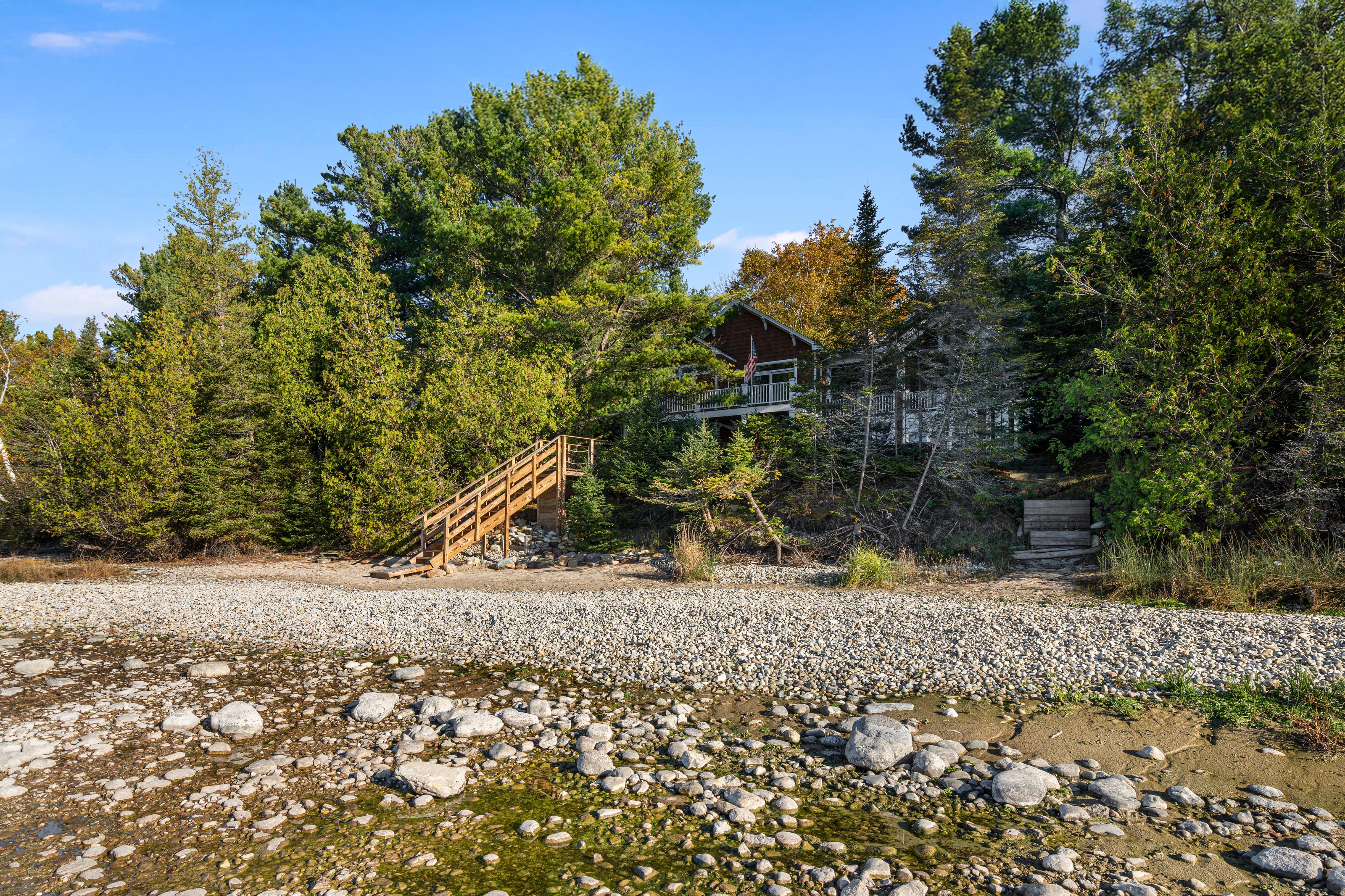 Exterior photographs of 4093 Lake Shore Drive in Charlevoix, this gem is listed at $2,099,900 through Berkshire Hathaway HomeServices Michigan Real Estate – Traverse City and The Crane Group with associate broker Johnny Crane and his brother, co-listing agent Matt Crane.
