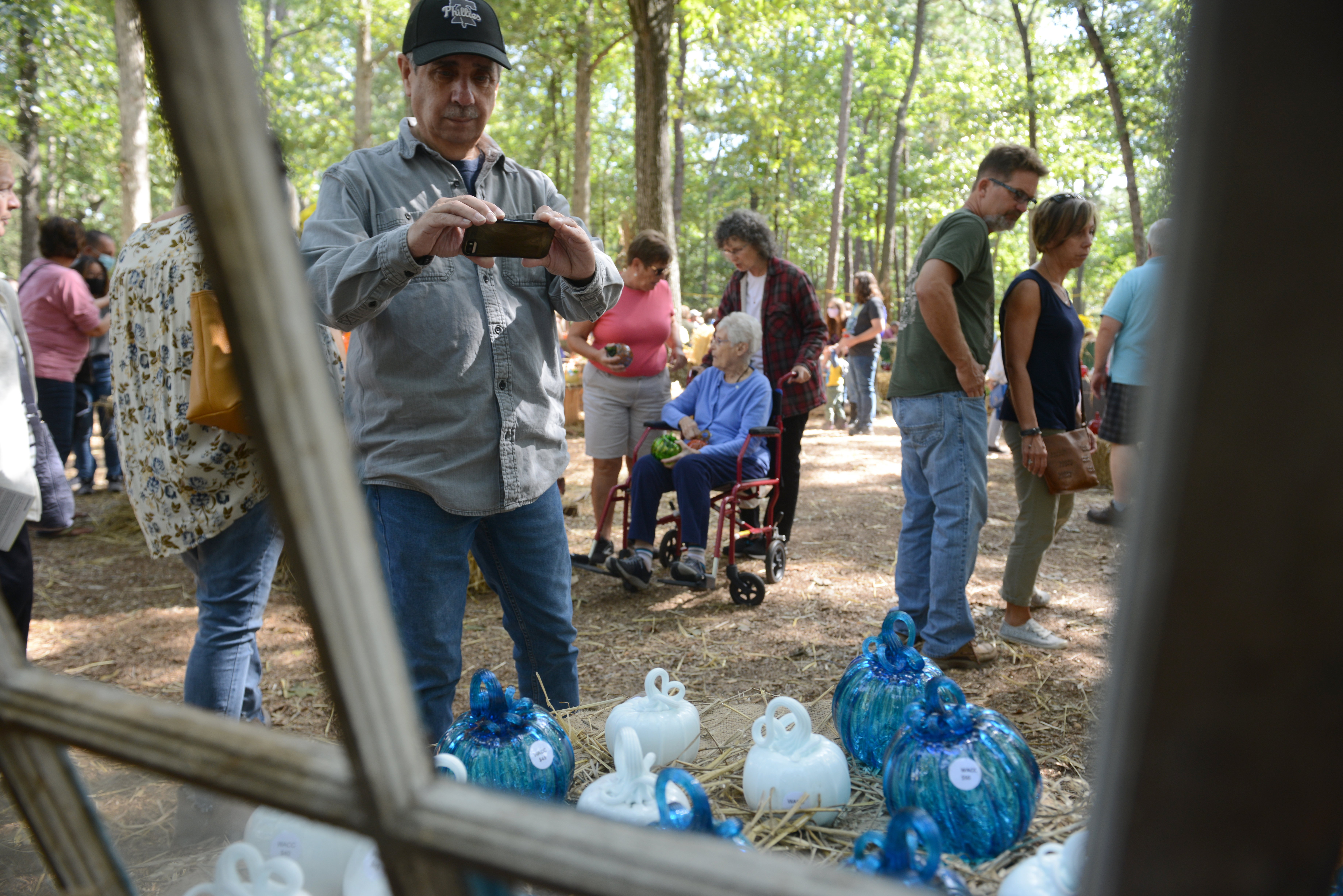 Customers browse the glass pumpkin patch during the 22nd annual Festival of Fine Craft at Wheaton Arts in Millville, Saturday, Oct. 2, 2021.