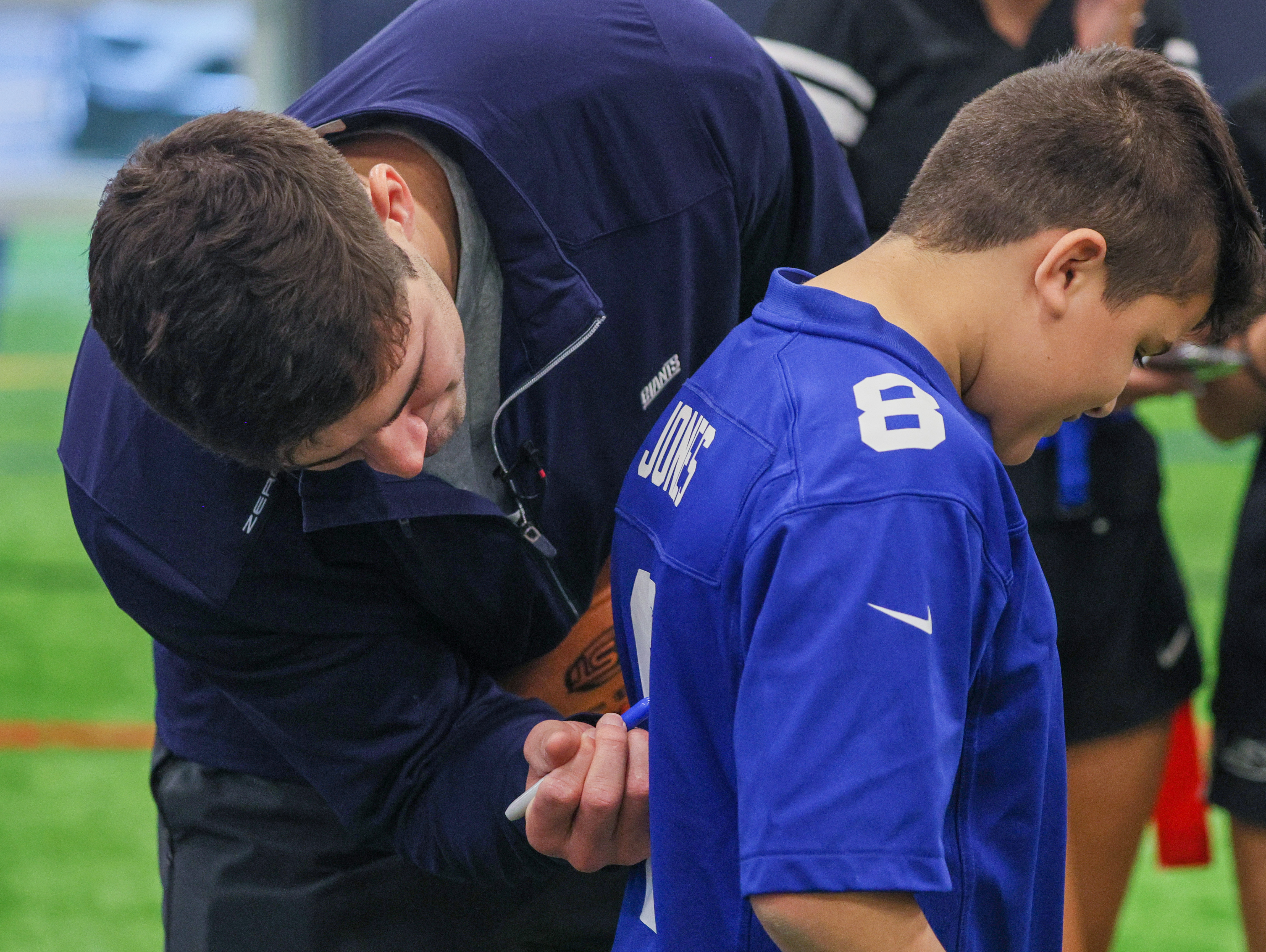 Giants QB Daniel Jones helps to kickoff girls flag football