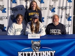 Kittatinny's Clare Schwartz, center, signs her NLI to continue her swimming career at Drexel University.