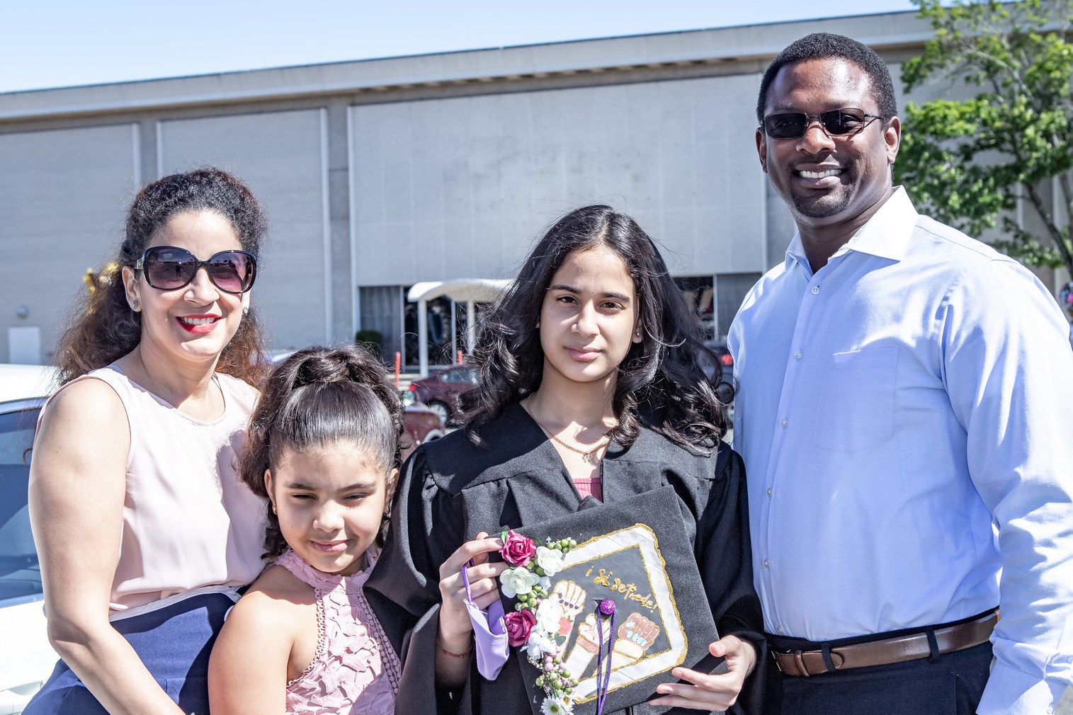 Amalie Almonte and family pose for a photo at the Veritas Prep Charter School 8th grade 2020 DRIVE-In Graduation held in the parking lot of the Eastfield Mall. (Danny Nason Photo)