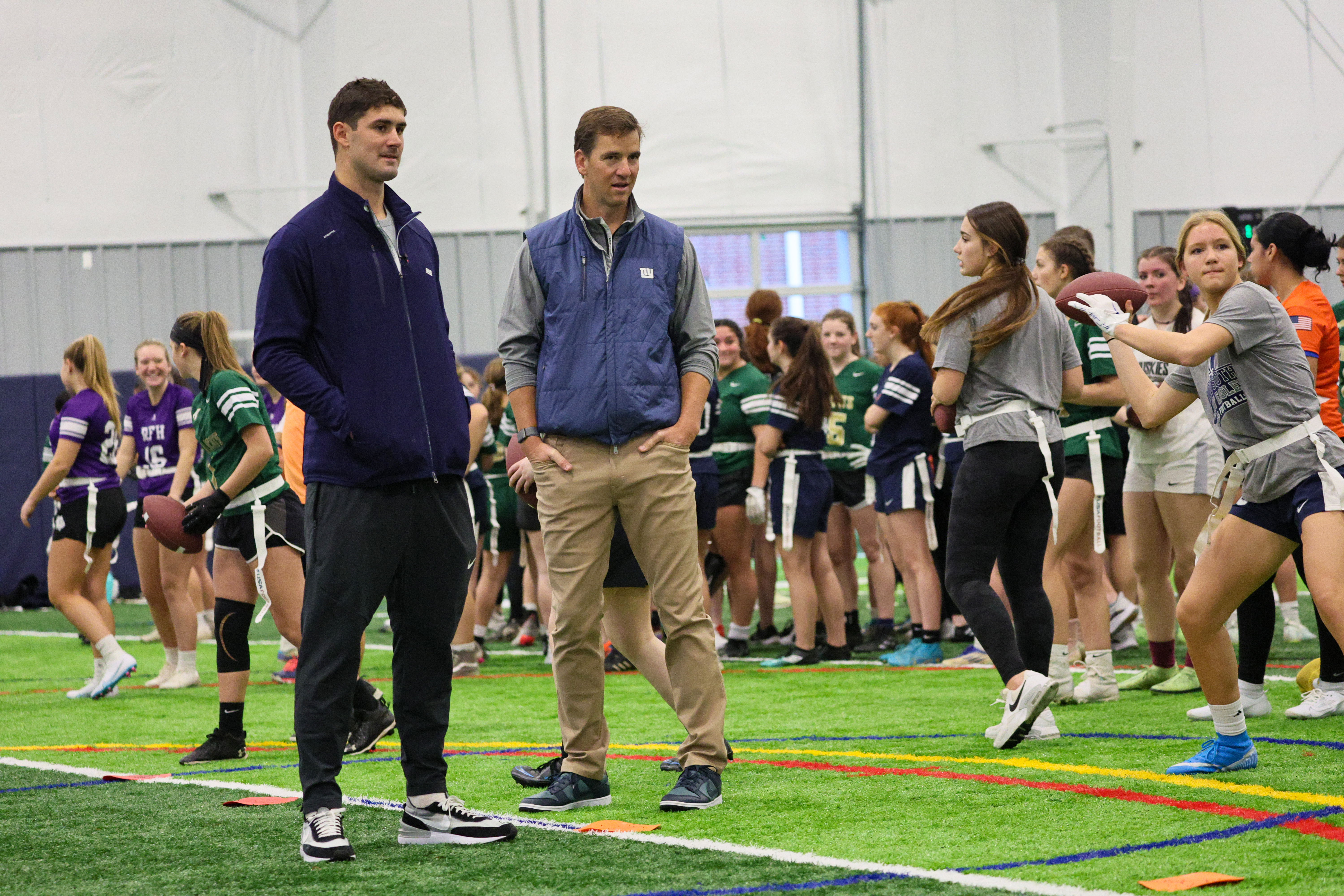 Eli Manning and Daniel Jones help with Girls Flag Football clinic