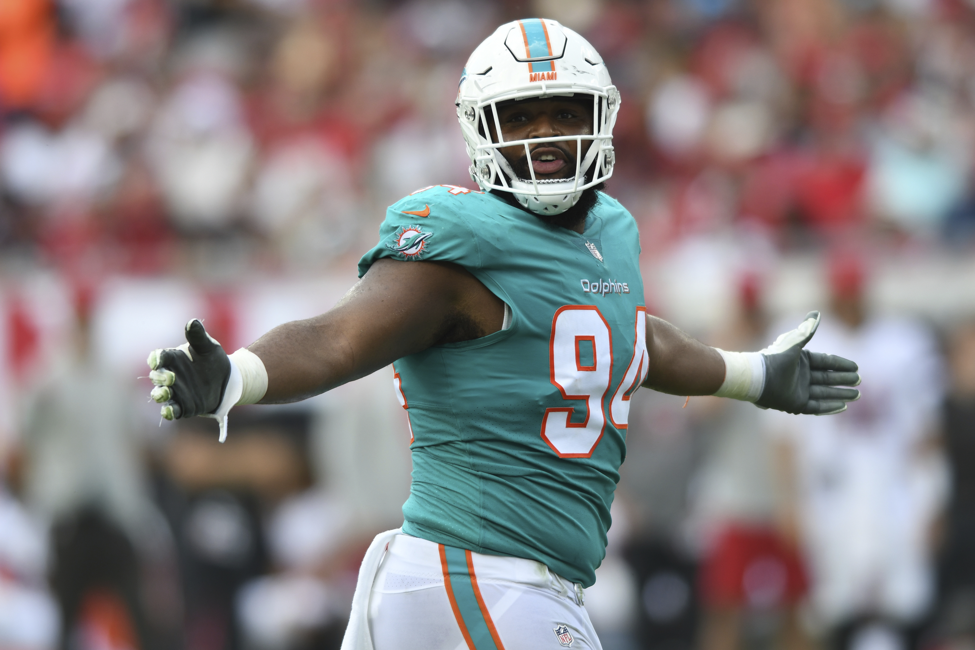 Mike Gesicki of the Miami Dolphins is tackled by Myles Jack of the