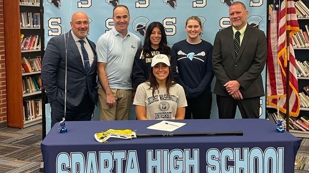 Leah Moore will continue her lacrosse career at George Washington University.  Pictured are: Back row: Dr. Ed Lazzra, Principal; David Moore; Michelle Moore; Alex Takacs, head coach and Steve Stoner, AD
Front row: Leah Moore