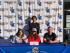 Kittatinny's Aniella Casper, center, signs her NLI to continue her lacrosse career at Newberry College.